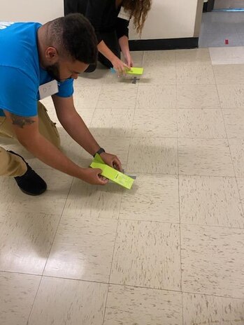 A workshop attendee prepares to test his paper glider at the U.S. Naval Academy (USNA) in Annapolis in October 2024. The USNA’s STEM Center for Education and Outreach hosted a STEM workshop and demonstrated easy, low-cost material assembly projects Navy STEM representatives can introduce to their local communities. Strategic Systems Programs STEM leads used this opportunity to network and participated on hands-on science projects at the base including rusting a dog tag, creating a long-range paper glider, and manipulating artificial intelligence to aggregate images.