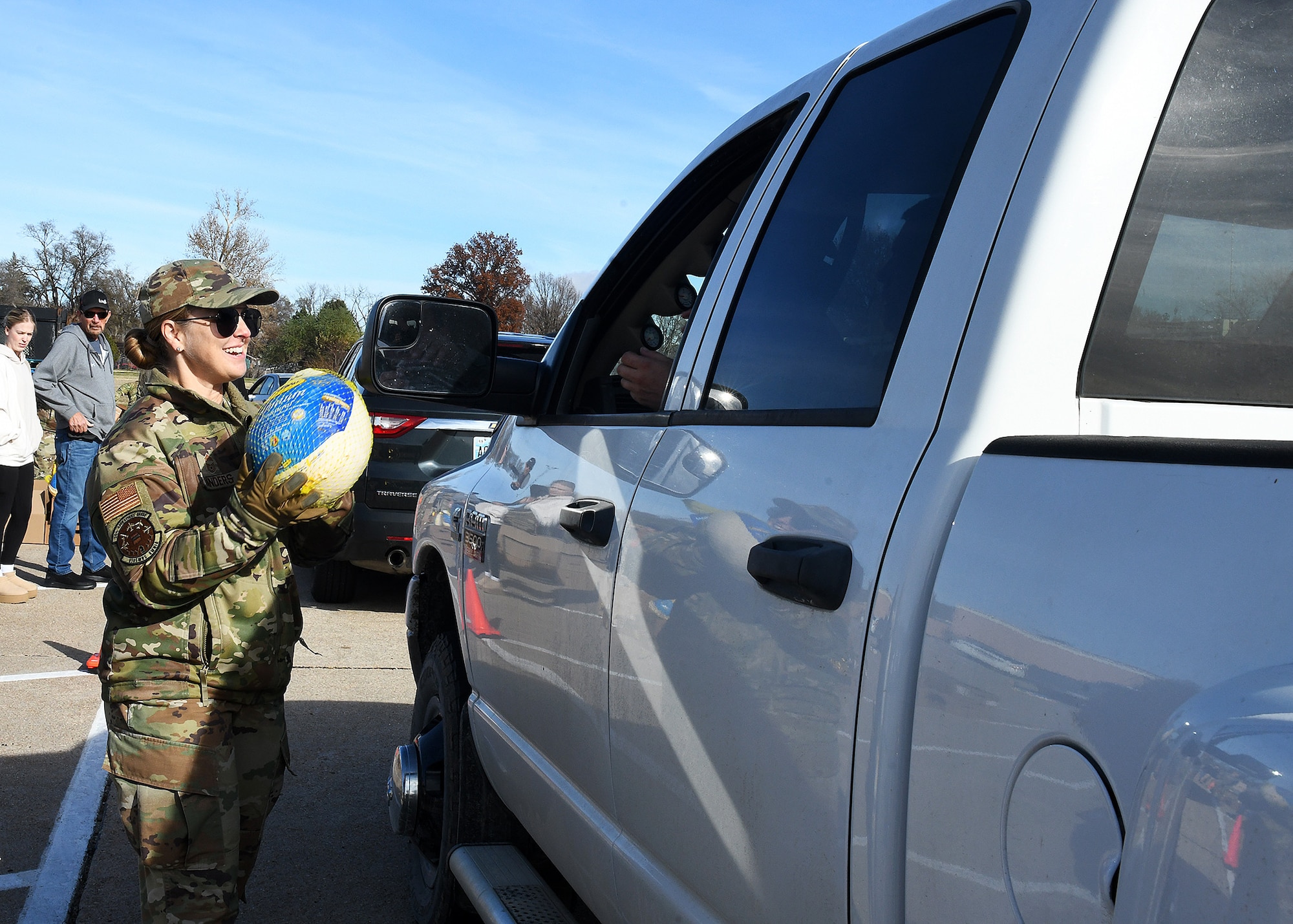 Airmen gives a turkey to Offutt service member