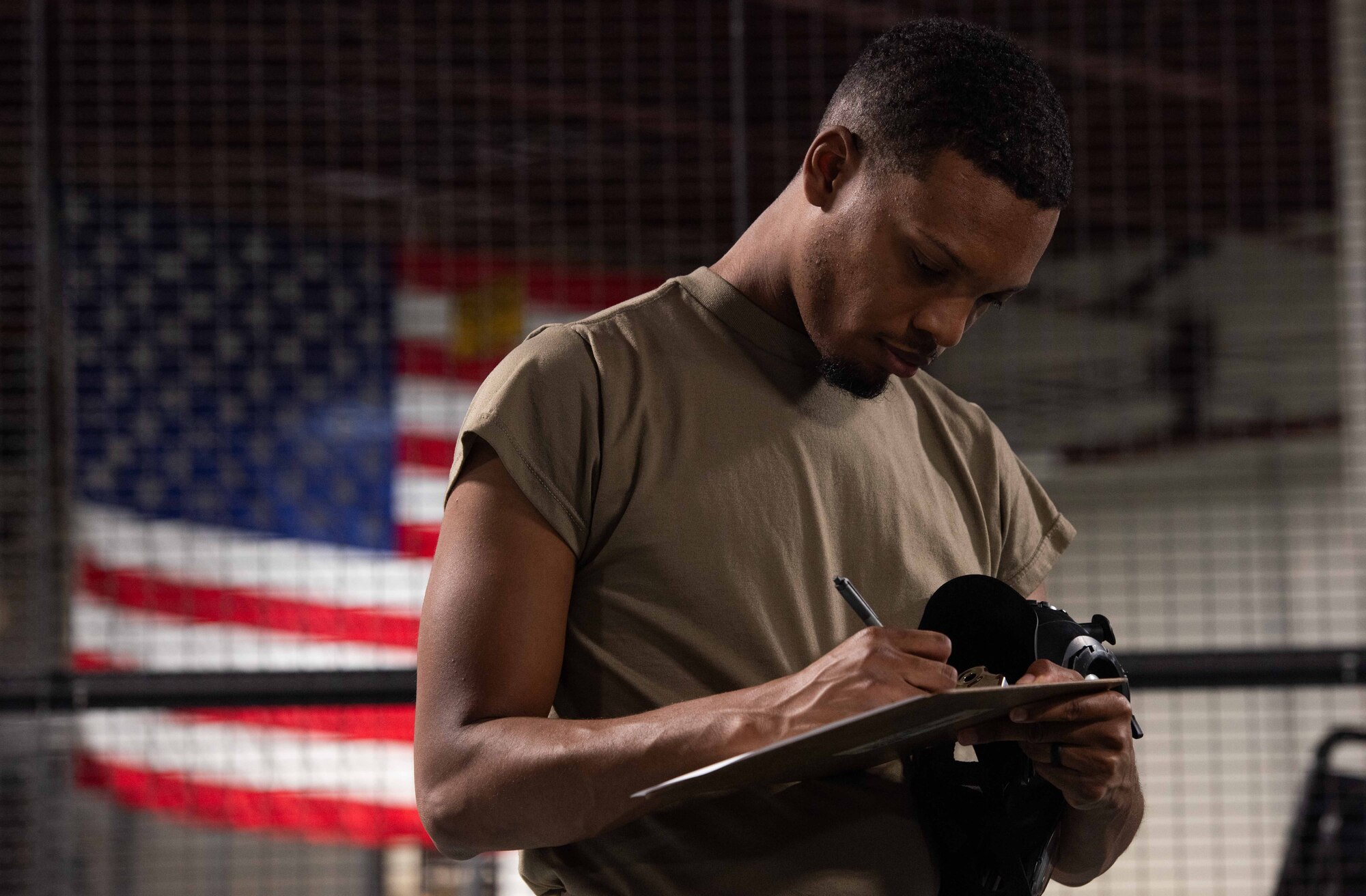 Airman 1st Class Stephon Owens, 4th Logistics Readiness Squadron Individual Protective Equipment (IPE) journeyman, logs personal protective equipment information.