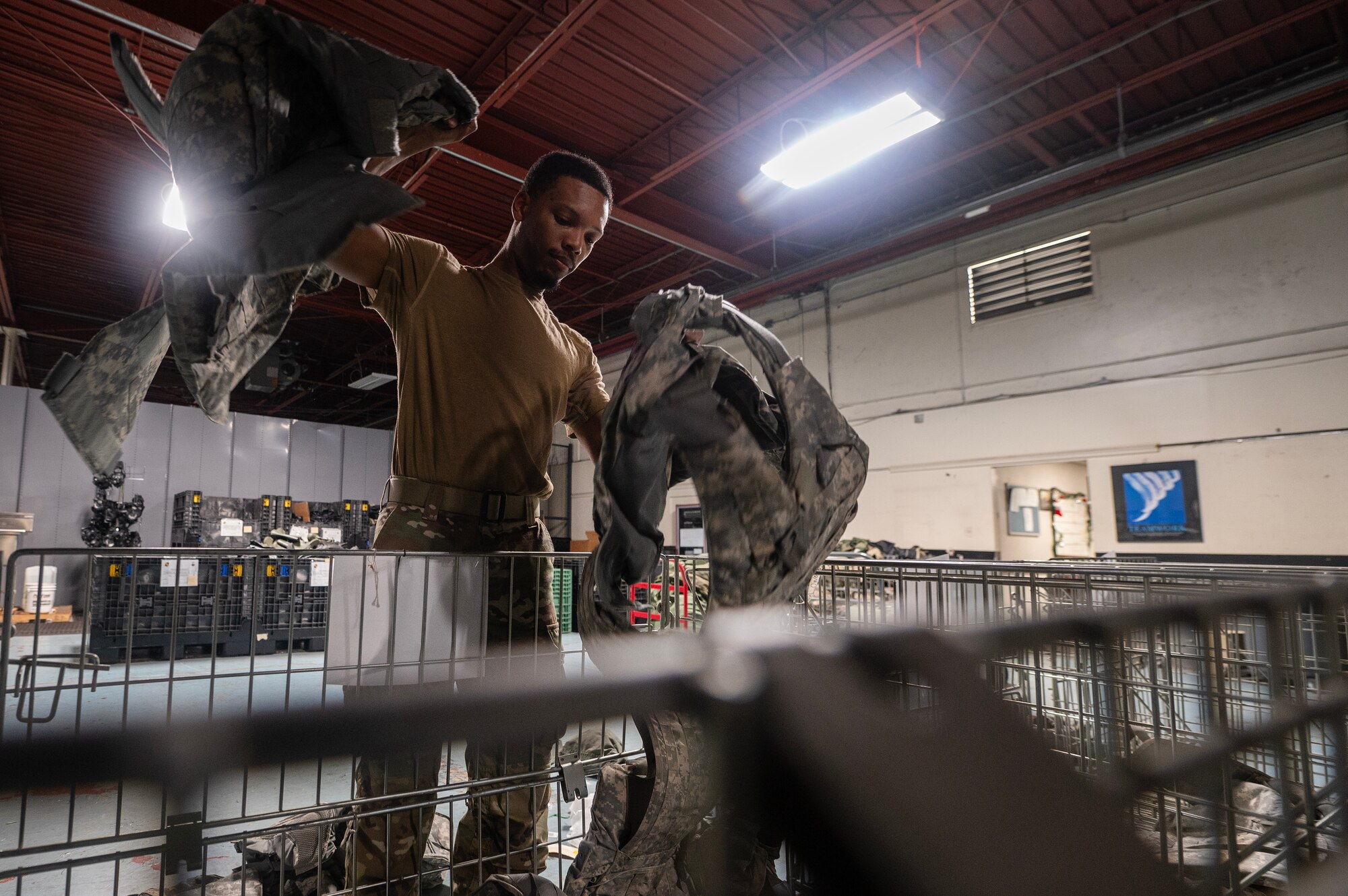 Airman 1st Class Stephon Owens, 4th Logistics Readiness Squadron Individual Protective Equipment (IPE) journeyman, organizes protective equipment.