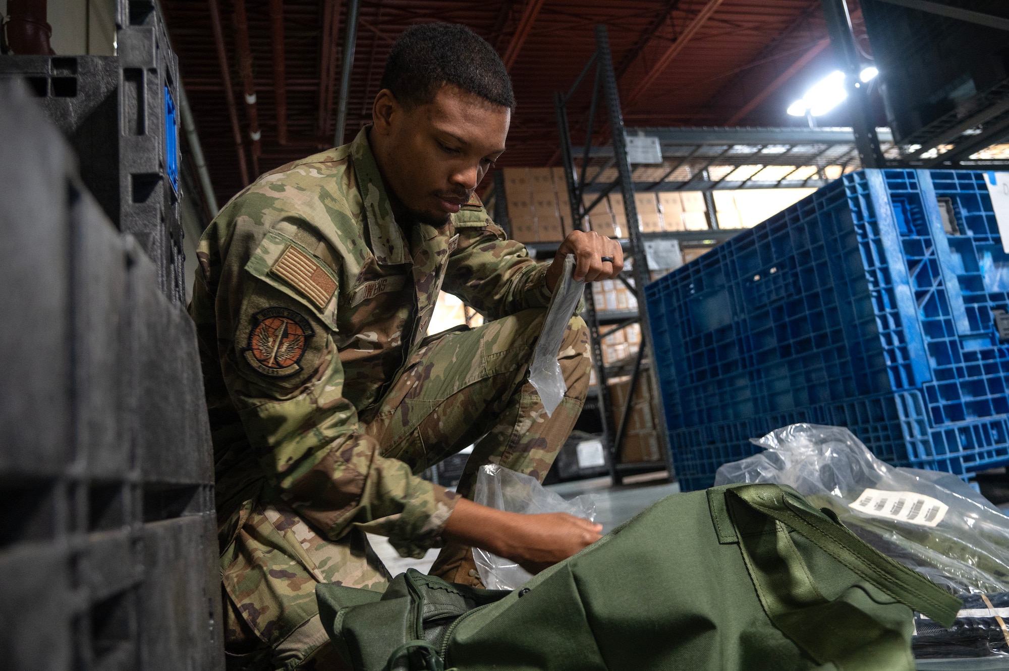 Airman 1st Class Stephon Owens, 4th Logistics Readiness Squadron Individual Protective Equipment (IPE) journeyman, organizes protective equipment.