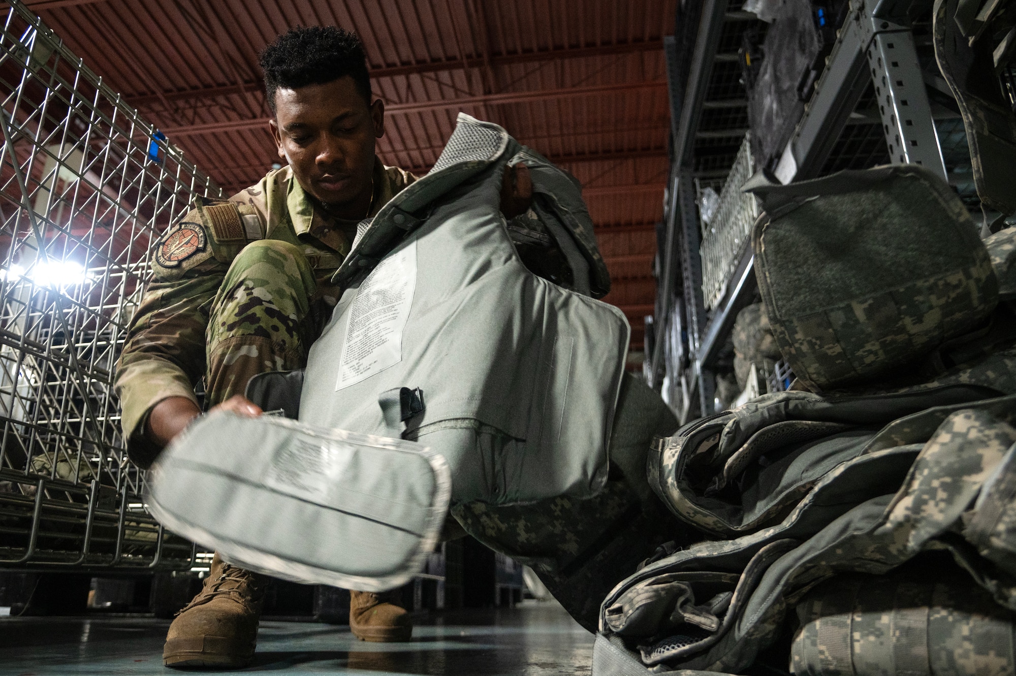 Airman 1st Class Grecy Chady, 4th Logistics Readiness Squadron Individual Protective Equipment (IPE) Journeyman, verifies a serial number assigned to an Interceptor Body Armor vest.