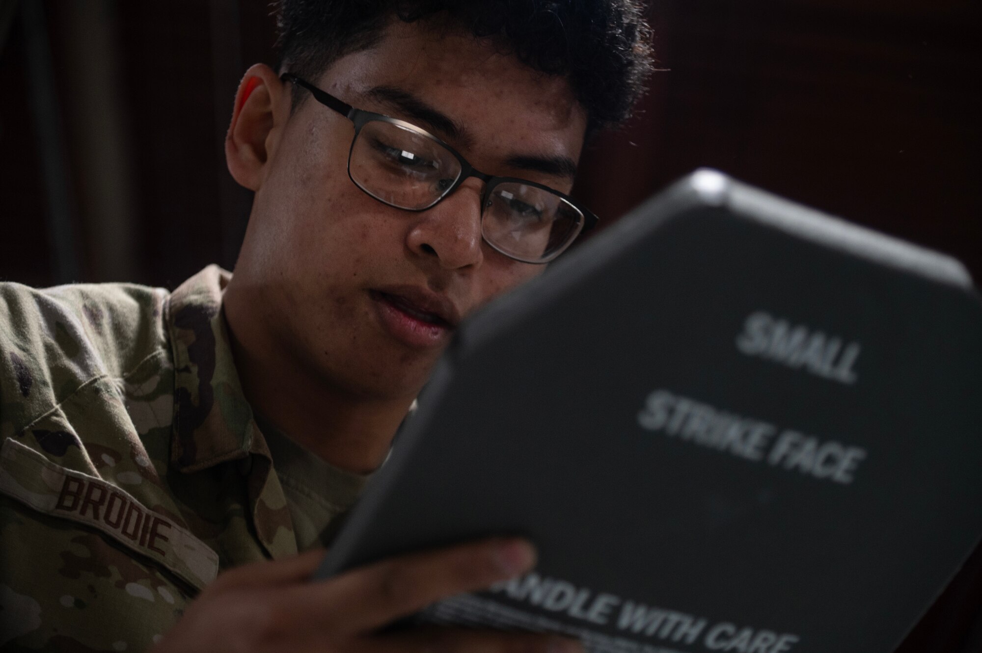 Airman John Matt Brodie, 4th Logistics Readiness Squadron Individual Protective Equipment (IPE) apprentice, verifies a serial number assigned to an Interceptor Body Armor plate.