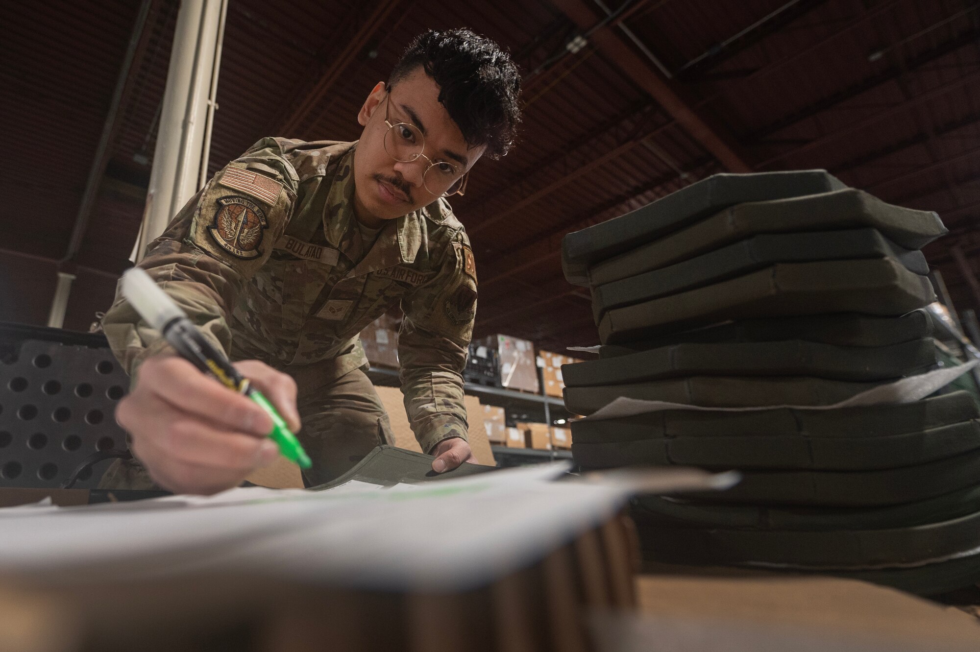 SrA Bulatao, 4th Logistics Readiness Squadron Individual Protective Equipment (IPE) journeyman, verifies a serial number assigned to an Interceptor Body Armor plate.