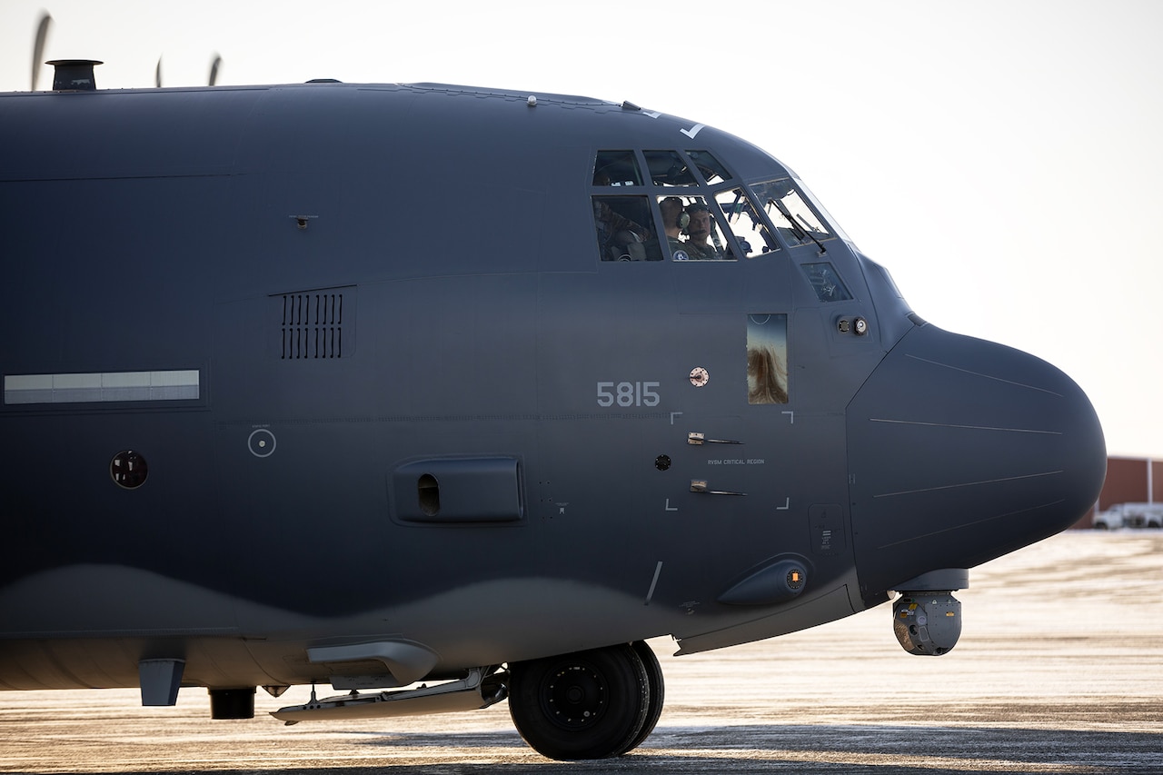 A large aircraft nose sits parked on tarmac during the day.