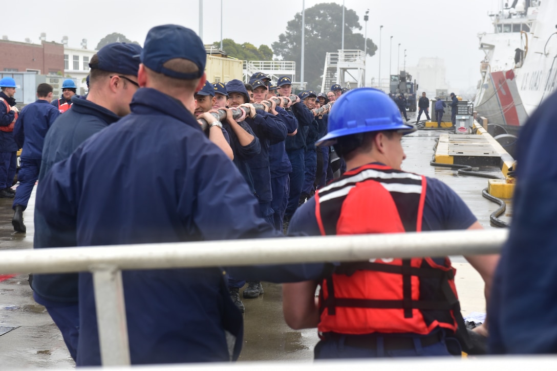 Crew members of the U.S. Coast Guard Cutter Munro (WMSL 755) assist with shore ties, Nov. 25, 2024, after a two-month counter-drug patrol in international waters in the Eastern Pacific Ocean. Before returning to Alameda, California, Munro conducted a bulk offload of illicit narcotics in San Diego in cooperation with federal agencies.  (U.S. Coast Guard photo by Petty Officer 3rd Class Danish Khan)