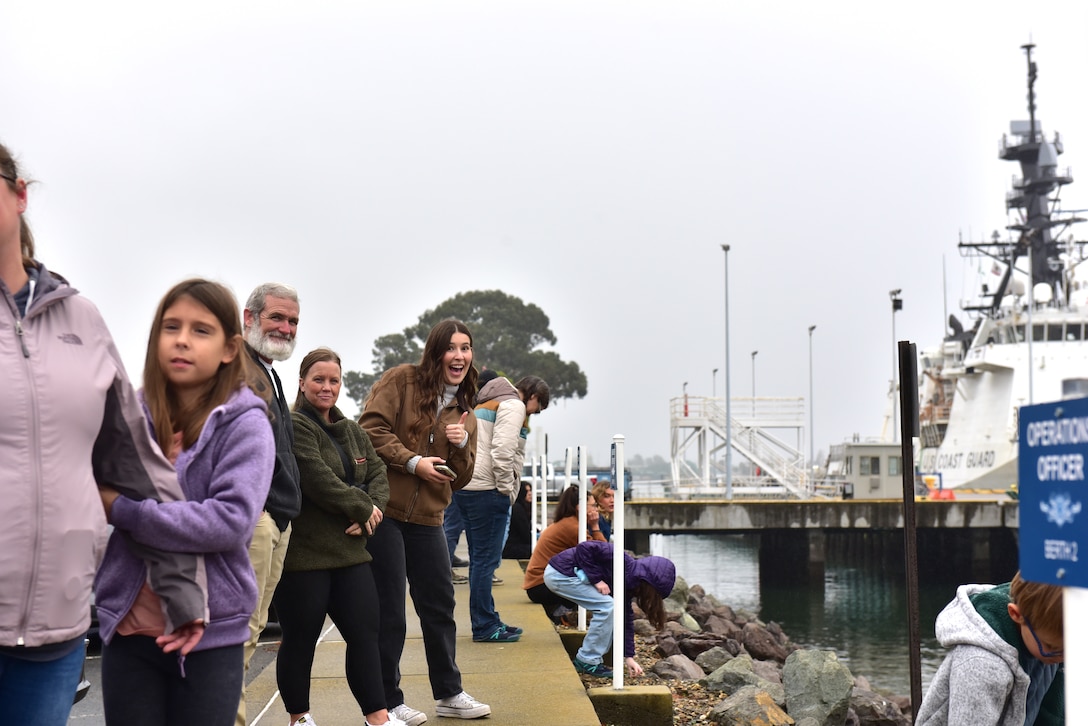 Families line up as they await to greet their Coast Guard crew members aboard the U.S. Coast Guard Cutter Munro (WMSL 755) returning home to Alameda, Calif., Nov. 25, 2024. The Munro crew were on a two-month counter-drug patrol in international waters off the coasts of Central and South America in the Eastern Pacific Ocean. (U.S. Coast Guard photo by Petty Officer 3rd Class Danish Khan)