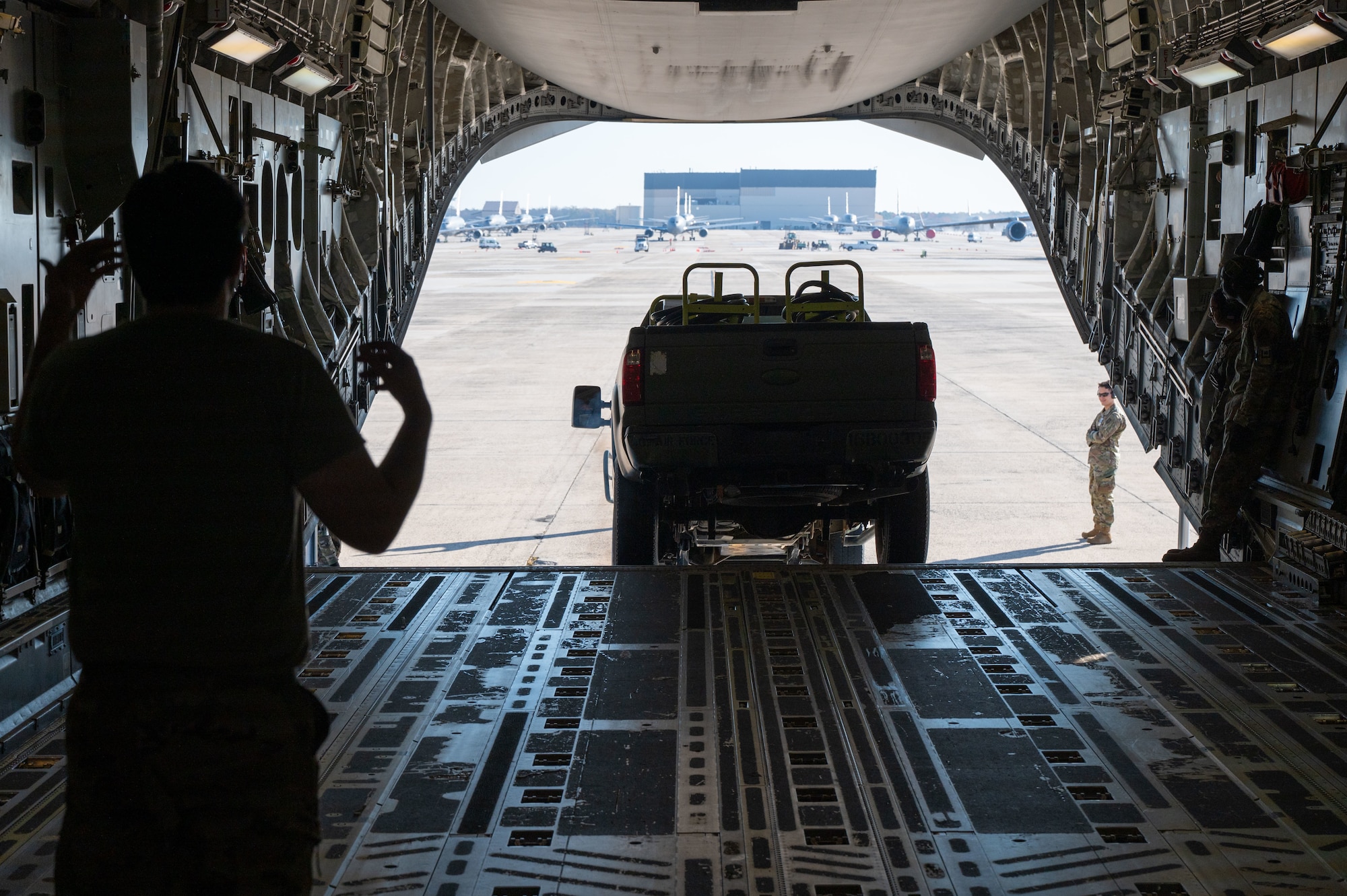 U.S. Airmen load equipment into aircraft