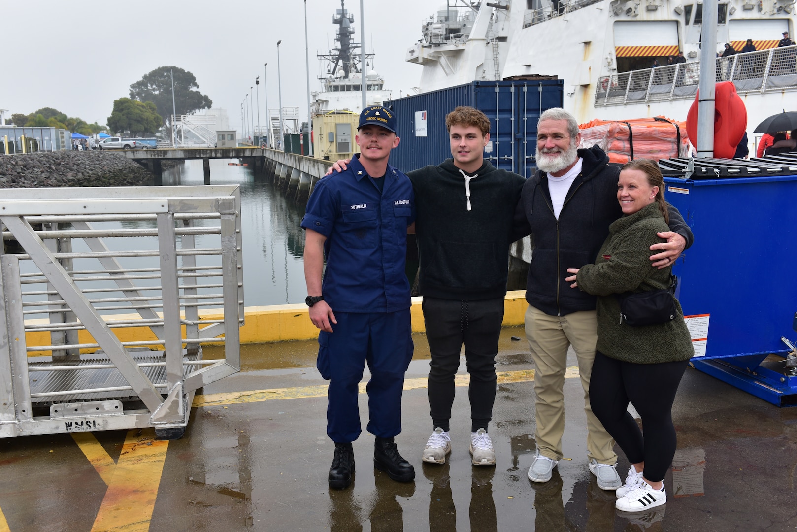 U.S. Coast Guard Cutter Munro (WMSL 755) crew member reunites with his family after the cutter returned to its homeport at Base Alameda, California, Nov. 25, 2024, following a two-month Eastern Pacific patrol. Munro is one of four Legend-class national security cutters homeported in Alameda. (U.S. Coast Guard photo by Petty Officer 3rd Class Danish Khan)