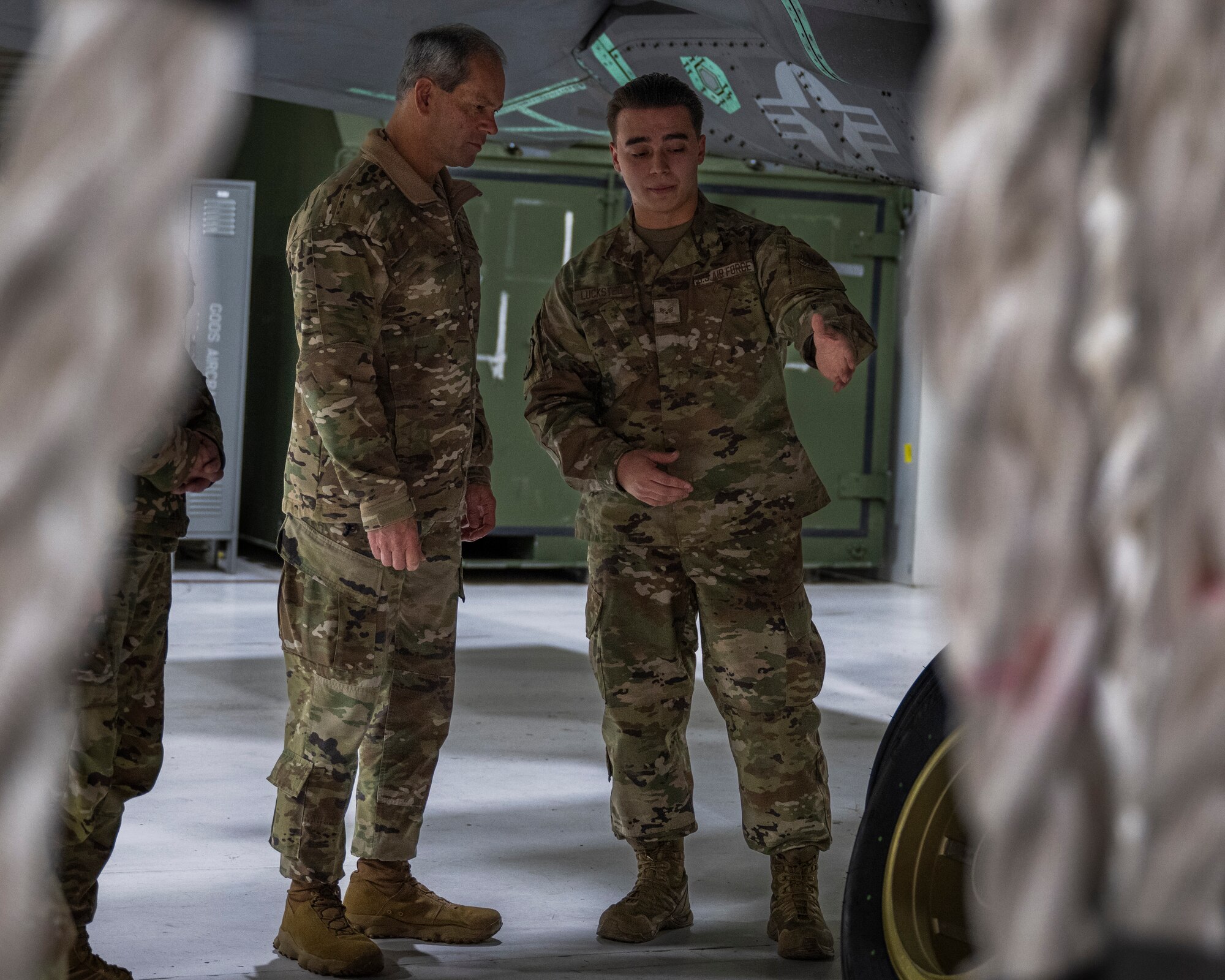 A photo of an Airman briefing a general beside an F-35A Lightning II