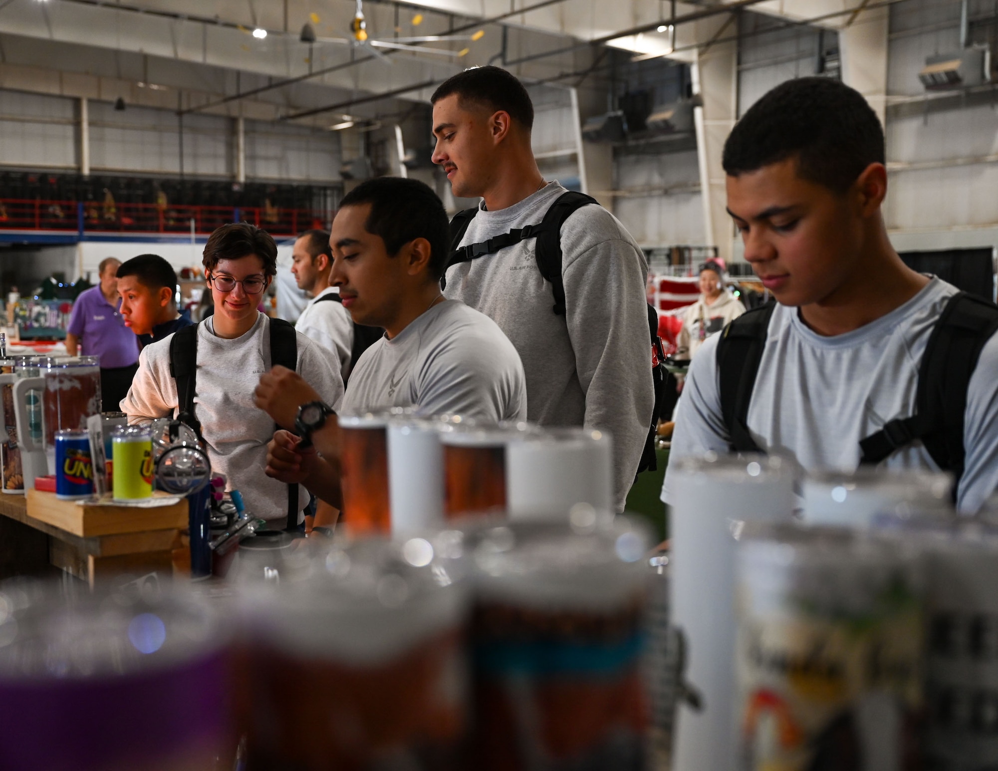 U.S. Air Force Airmen assigned to the 312th Training Squadron browse different travel cups for sale during the 42nd annual Santa’s Market and 2nd annual Base Open House at the Louis F. Garland Department of Defense Fire Academy, Goodfellow Air Force Base, Texas, Nov. 23, 2024. Santa’s Market originated as a small holiday craft market for students on base and has grown to a large-scale community experience with more than 100 vendors. (U.S. Air Force photo Airman 1st Class Evelyn J. D’Errico)