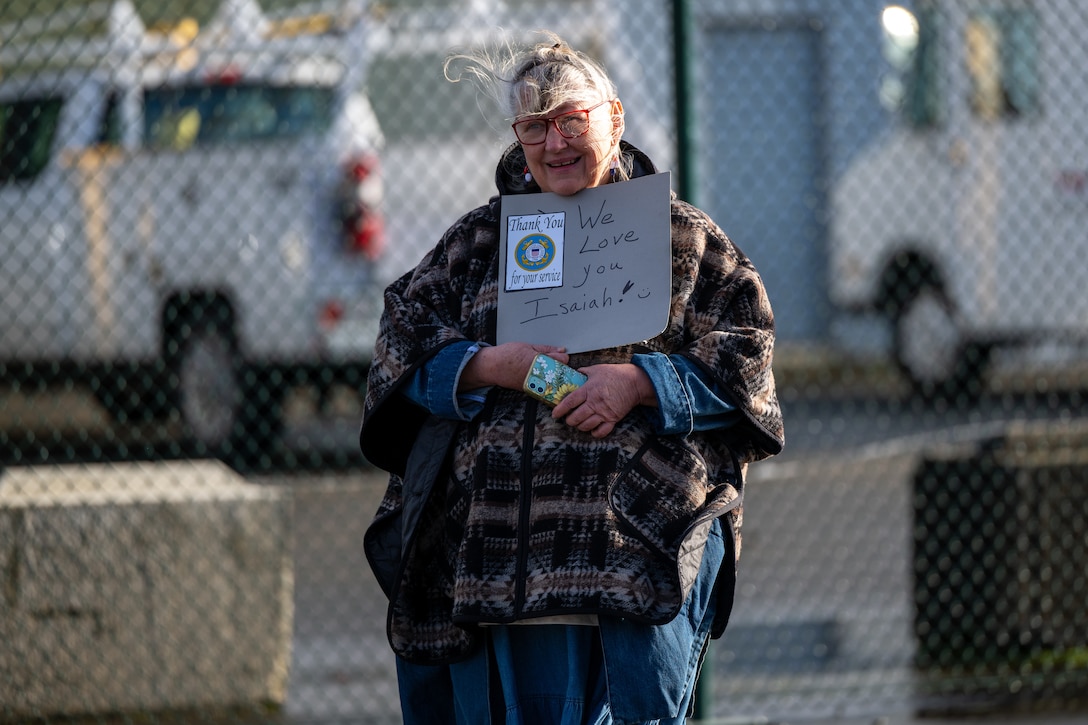 A family member holds a farewell sign for the departure of U.S. Coast Guard Cutter Polar Star (WAGB 10) at Coast Guard Base Seattle, Washington, Nov. 22, 2024. The crew of the Polar Star are beginning their voyage to Antarctica in support of Operation Deep Freeze, the annual joint military mission to resupply the United States Antarctic stations. (U.S. Coast Guard photo by Petty Officer 2nd Class Briana Carter)