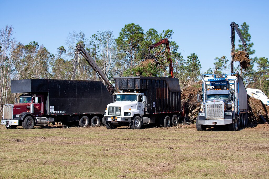 photo of three truck removal debris from a site.