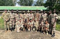 U.S. Army 1st Sgt. Derek Smith, 177th Regional Training Institute, Michigan National Guard; U.S. Air Force Capt. Andrew Layton, bilateral affairs officer, Michigan National Guard; and U.S. Army Master Sgt. Daniel Blaser, chief instructor, 177 RTI, with instructor cadre members at the Republic of Sierra Leone Armed Forces Training Center, Benguema, Sierra Leone, Nov. 19, 2024. The Michigan National Guard and the Republic of Sierra Leone Armed Forces signed an agreement Sept. 12 to become partners under the State Partnership Program.