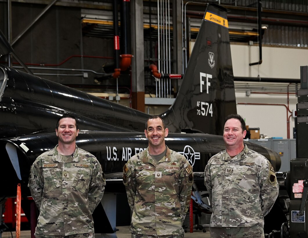 Airmen pose for photo in front of aircraft. (U.S. Air Force photo by Senior Airman Abigayl Salyer)