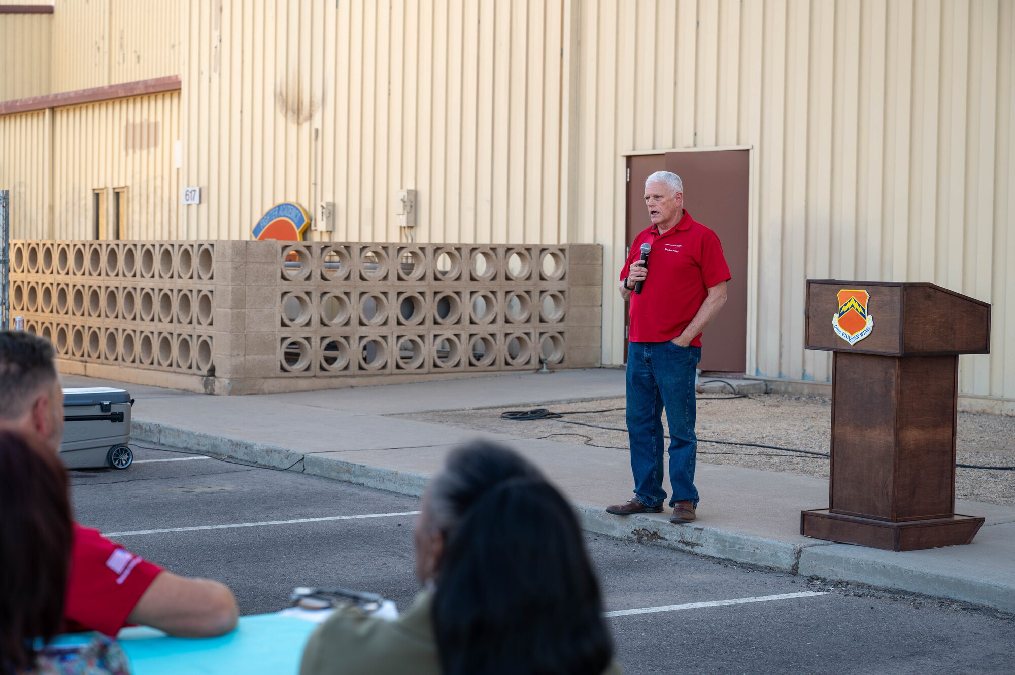Retired U.S. Air Force Col. Robert McCutchen, Lockheed Martin networked training center operations manager, gives remarks during a farewell ceremony for the last F-16 Fighting Falcon simulators, Nov. 22, 2024, at Luke Air Force Base, Arizona.