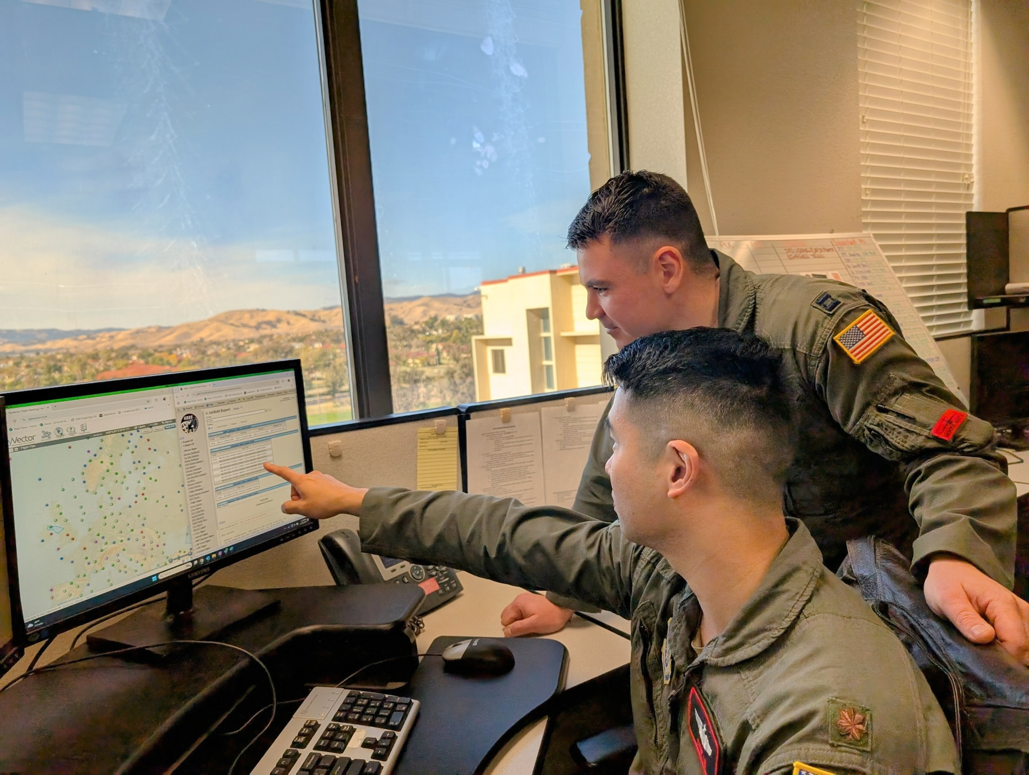 two men work at computer