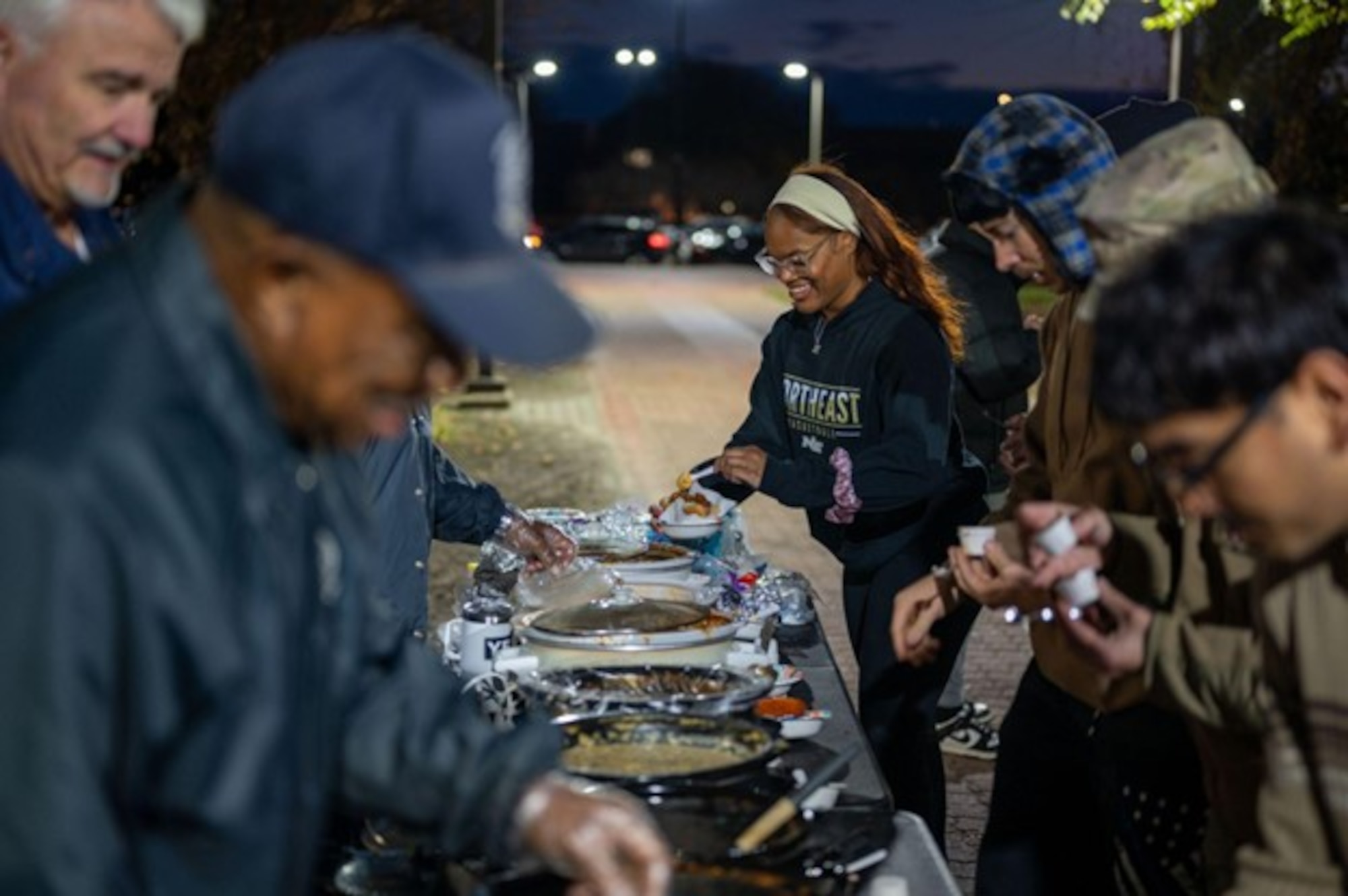 Airmen fill bowls with chili in a line. (U.S. Air Force photo by Airman Donnell Ramsey)