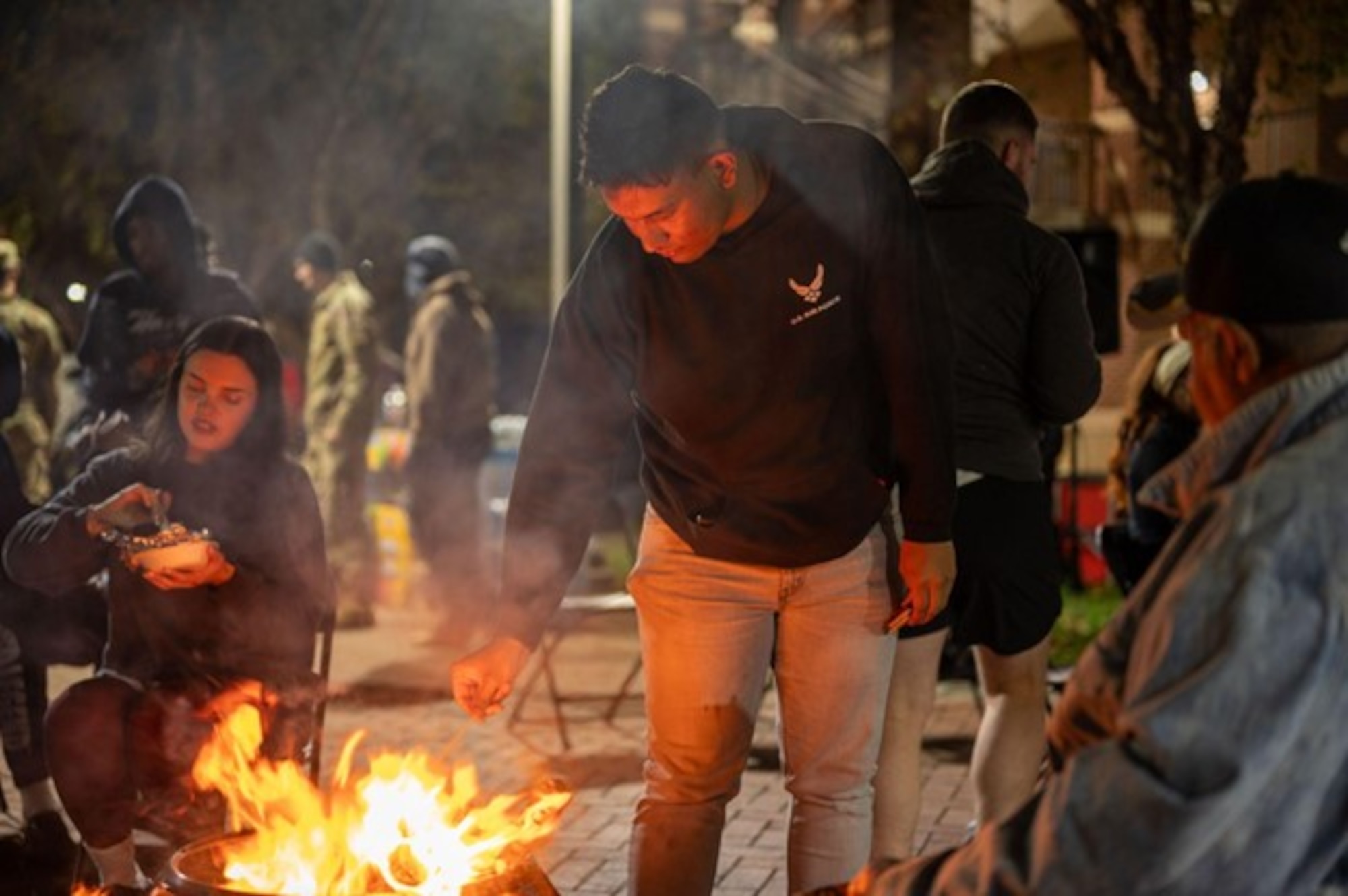Airman roasts a marshmallow over a fire. (U.S. Air Force photo by Airman Donnell Ramsey)