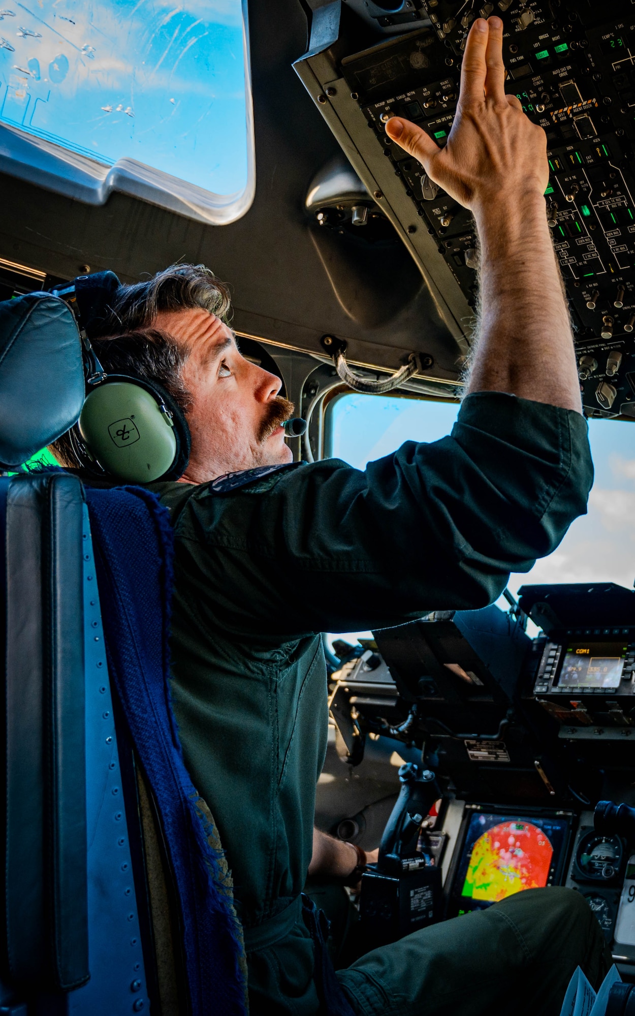U.S. Air Force Maj. Andrew Mazzarelli, 313th Airlift Squadron chief of standardization and evaluation, prepares for flight aboard a C-17 Globemaster III.