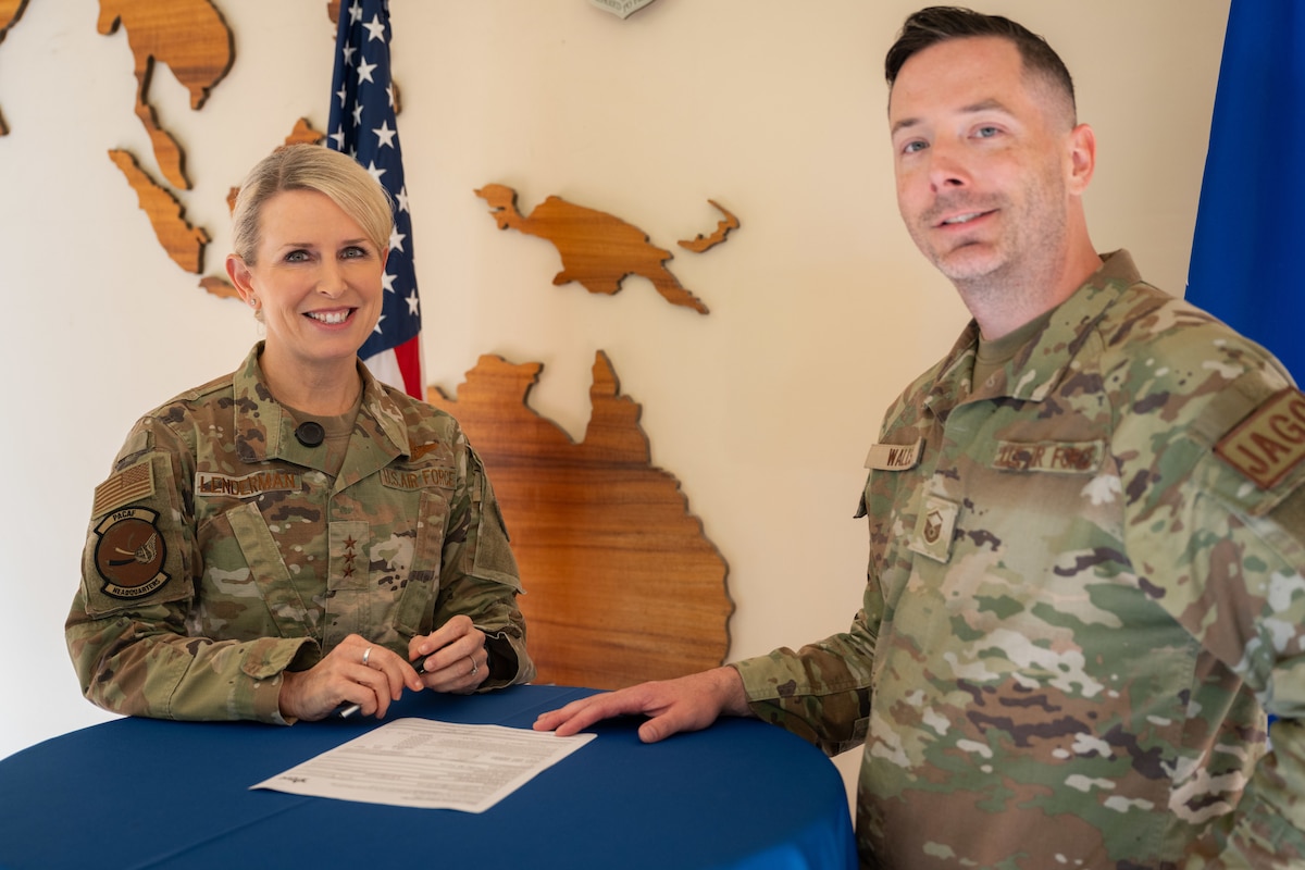 U.S. Air Force Lt. Gen. Laura Lenderman, Pacific Air Forces deputy commander, smiles after filling out a Combined Federal Campaign pledge form at Joint Base Pearl Harbor-Hickam, Nov. 18, 2024. Standing with her is Master Sgt. Christian Walls, CFC representative for PACAF headquarters. CFC is the world’s largest annual workplace charity campaign that raises millions of dollars each year. (U.S. Air Force photo by Tech. Sgt. Emerson Nuñez)