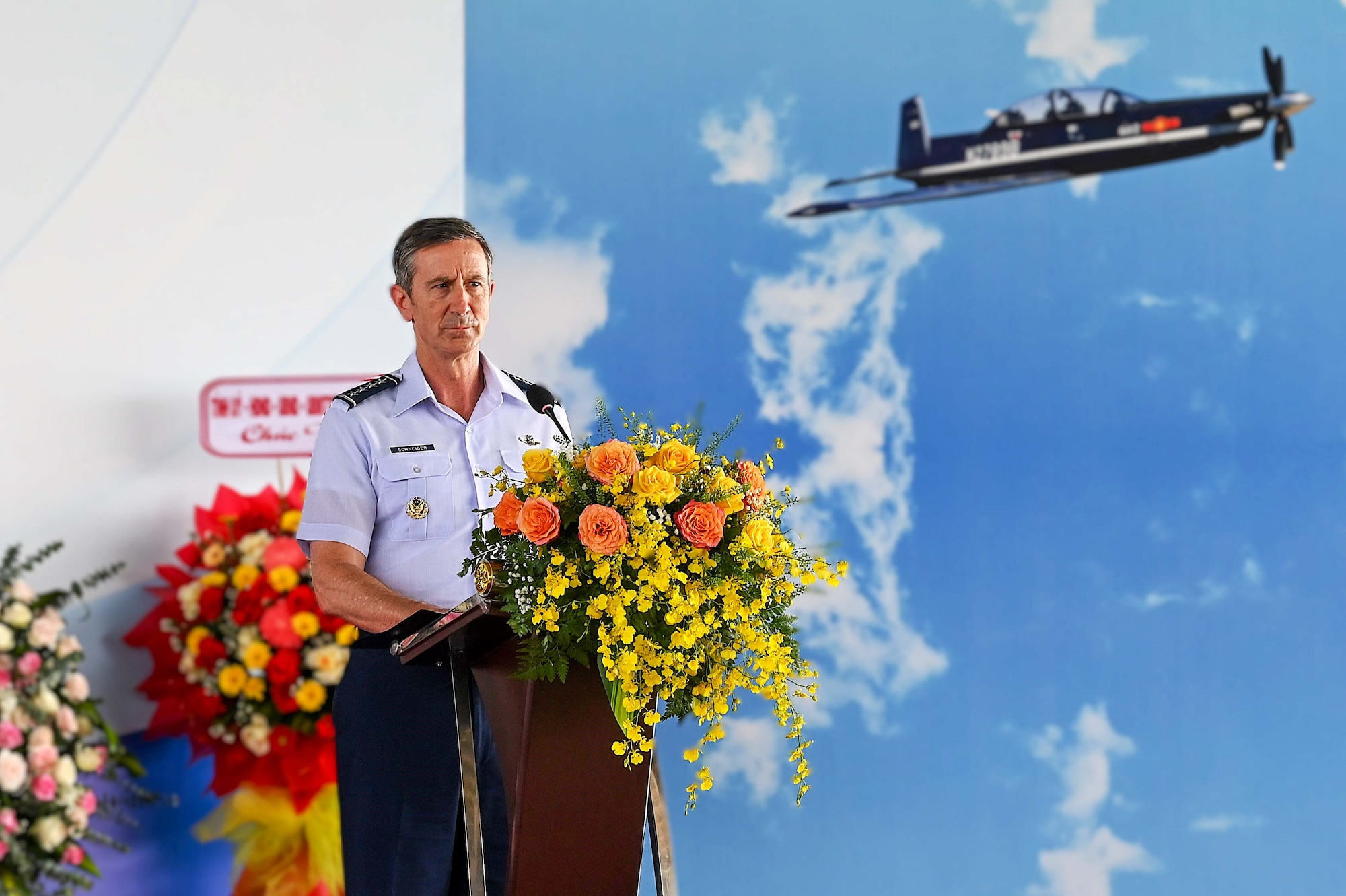 Pacific Air Forces Commander, Gen. Kevin Schneider, provides remarks at the Vietnamese Air Defence Air Force’s official acquisition ceremony for the T6-C training aircraft on Phan Thiet Air Base, Vietnam, Nov. 20, 2024. Schneider spoke to an audience of Vietnamese and U.S. military and official delegates. (U.S. Air Force photo by Staff Sergeant Elizabeth Taranto)