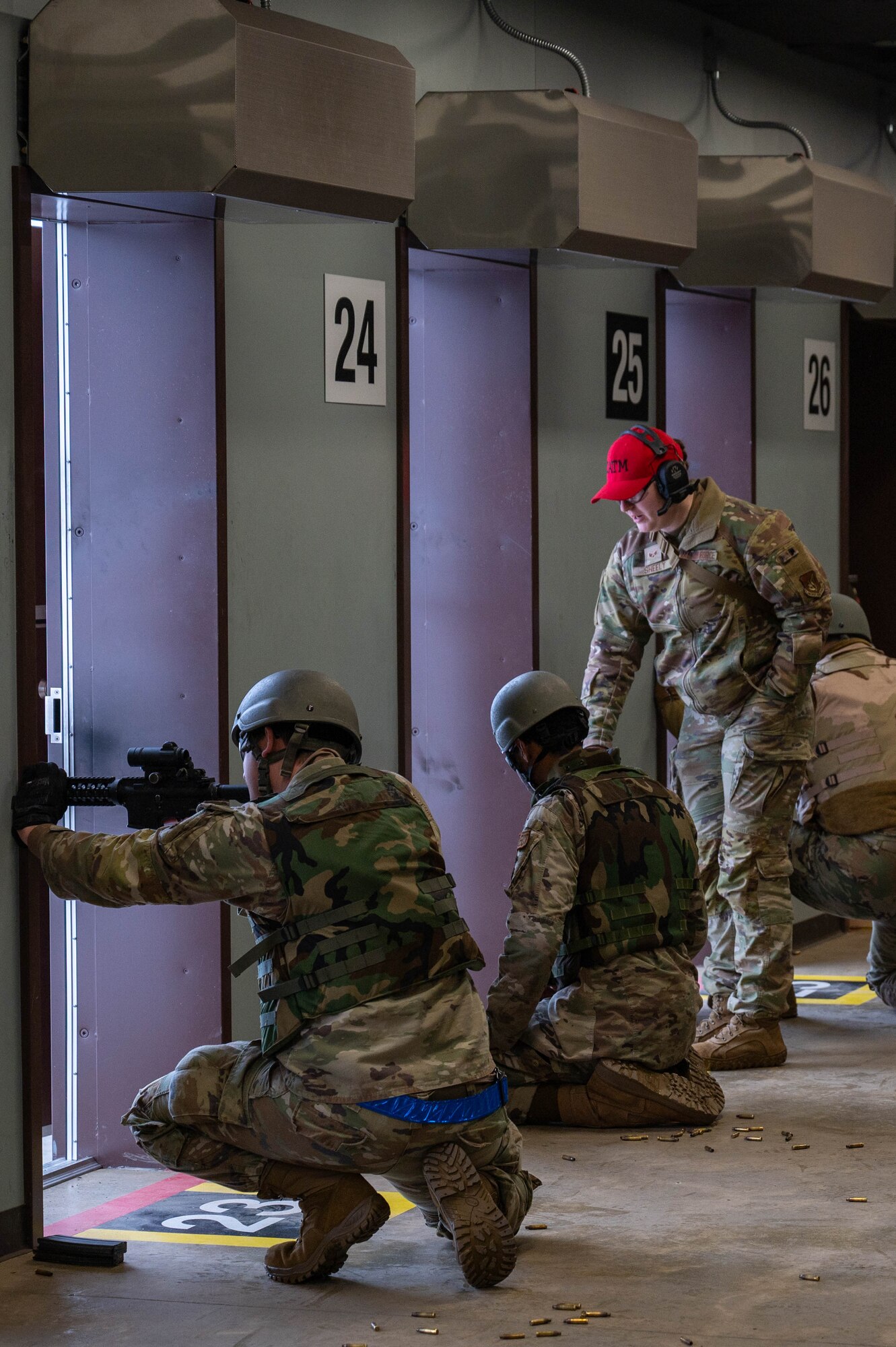 U.S. Air Force Senior Airman Megan Sheely-Alvarado, 354th Security Forces Squadron Combat Arms Training and Maintenance instructor, assists an Airman with their M4 carbine during a CATM course at Eielson Air Force Base, Alaska, Oct. 23, 2024.