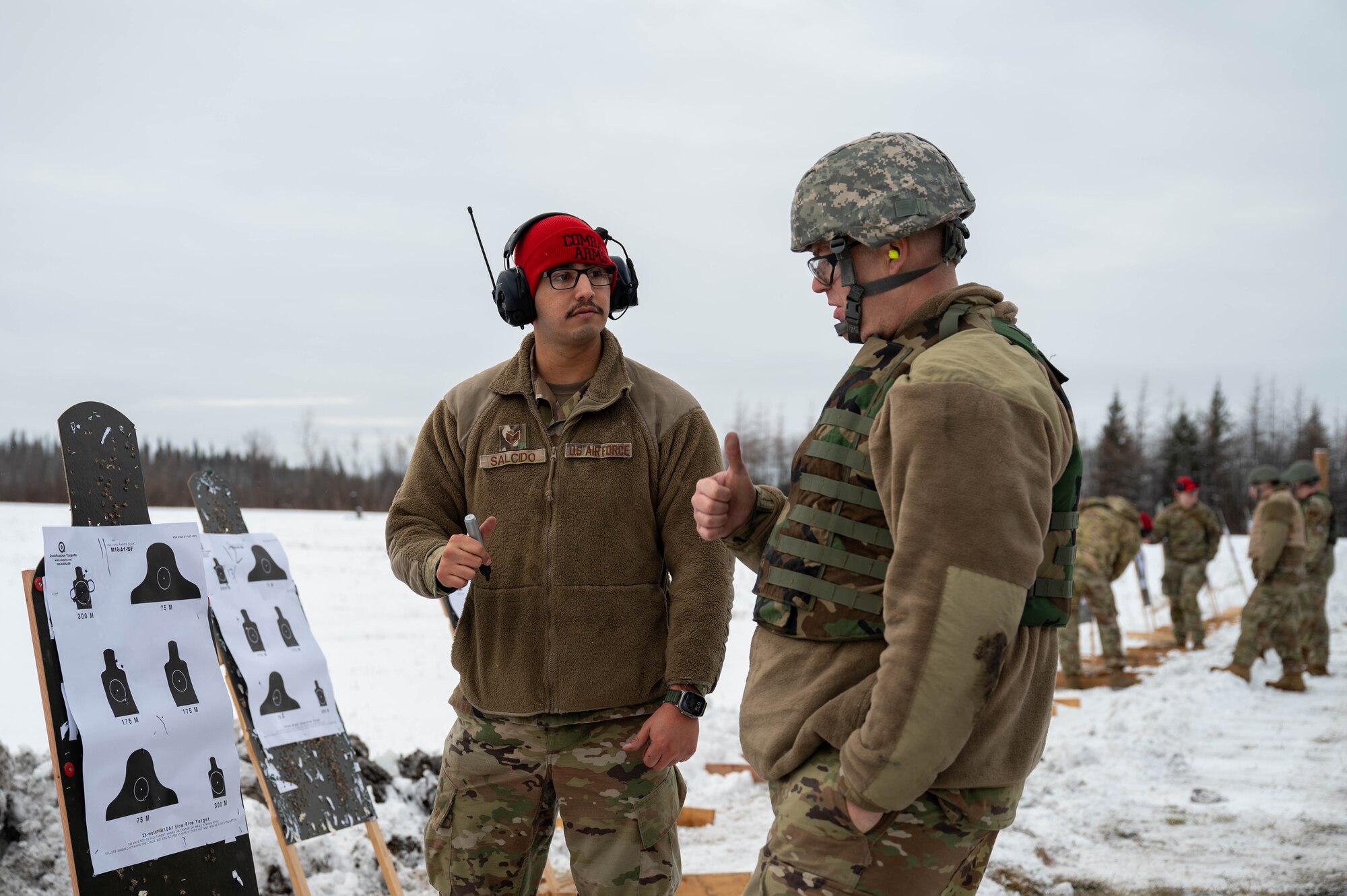 U.S. Air Force Staff Sgt. Patrick Salcido, 354th Security Forces Squadron Combat Arms Training and Maintenance instructor, advises an Airman on a zeroing target at a CATM course at Eielson Air Force Base, Alaska, Oct. 23, 2024.