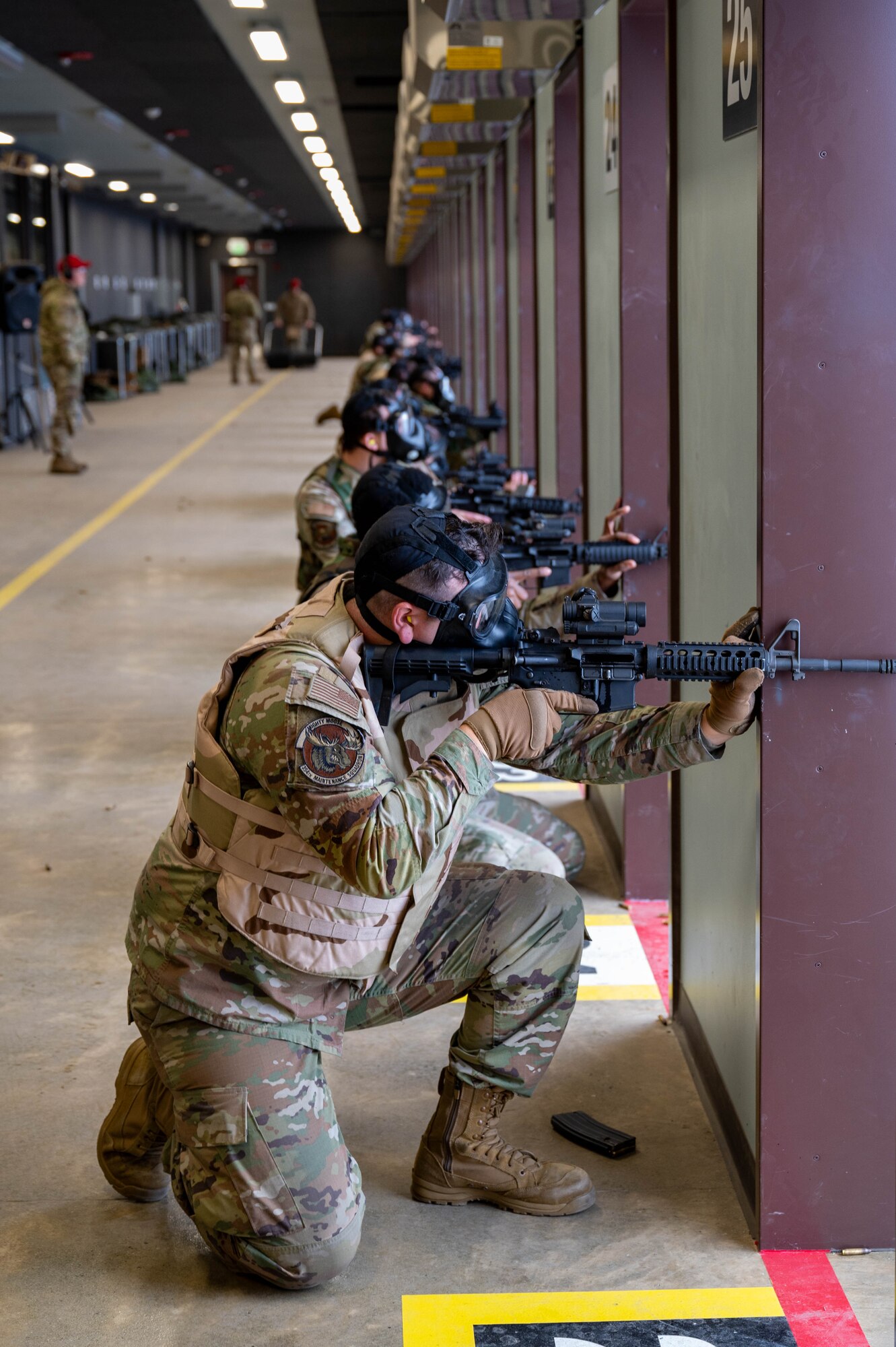 U.S. Air Force Airmen fire M4 carbines while wearing gas masks during a Combat Arms Training and Maintenance course at Eielson Air Force Base, Alaska, Oct. 23, 2024.