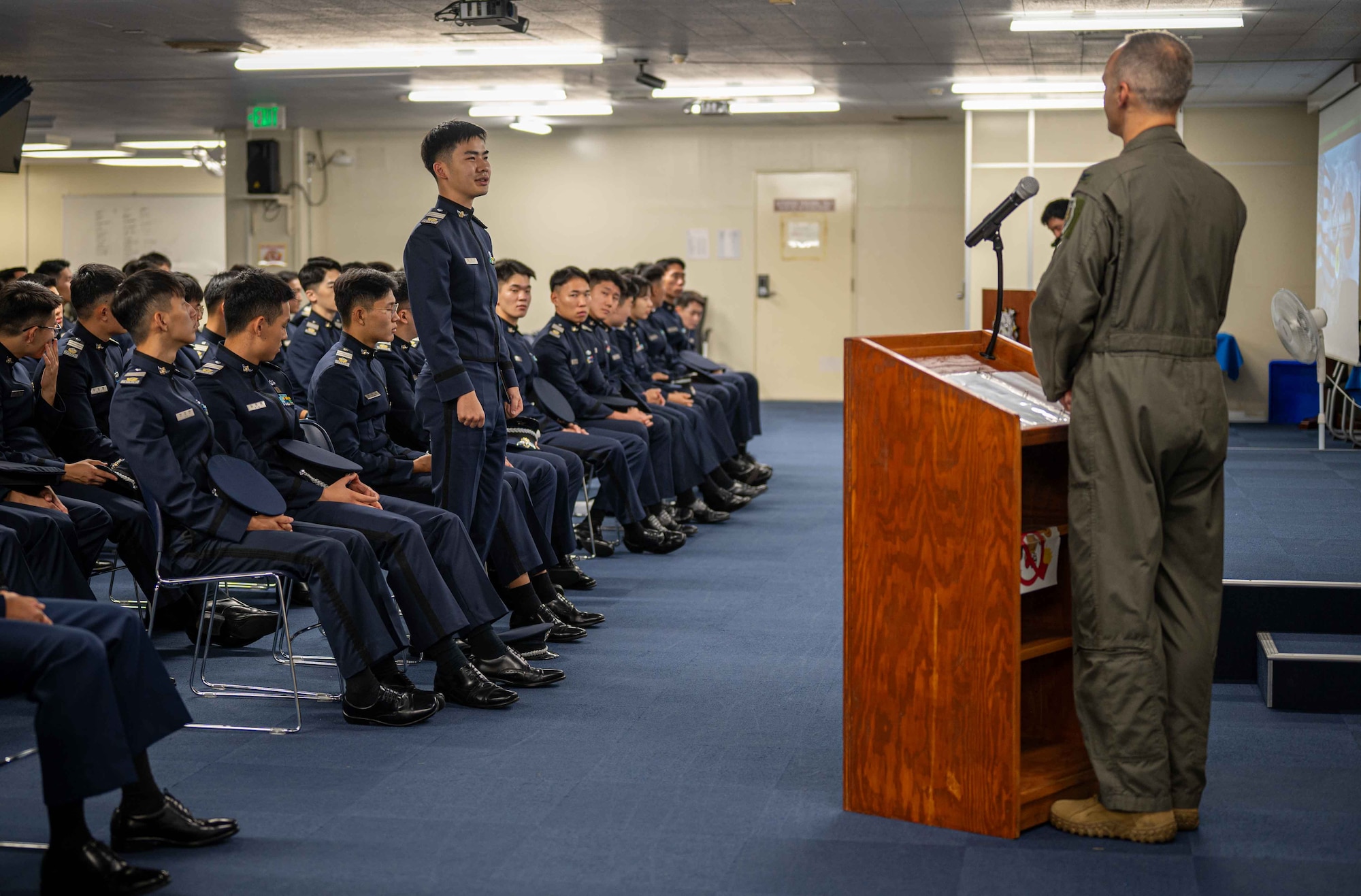 A Republic of Korea Academy student asks a question to U.S. Air Force Col. Joshua Lundeby, 18th Wing deputy commander, after a mission briefing at Kadena Air Base, Japan, Nov. 21, 2024.