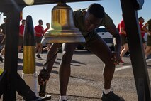 A new U.S. Marine of Alpha Company, 1st Recruit Training Battalion, rings the liberty bell during the company motivational run at Marine Corps Recruit Depot San Diego, California, Nov. 21, 2024. The company motivational run is a three-mile cadence run conducted around the Depot and is the last physical training event the Marines will conduct before they graduate from MCRD San Diego. The event is also the first-time friends and families will see their newly transformed Marines. (U.S. Marine Corps photo by Lance Cpl. Jacob Hutchinson)