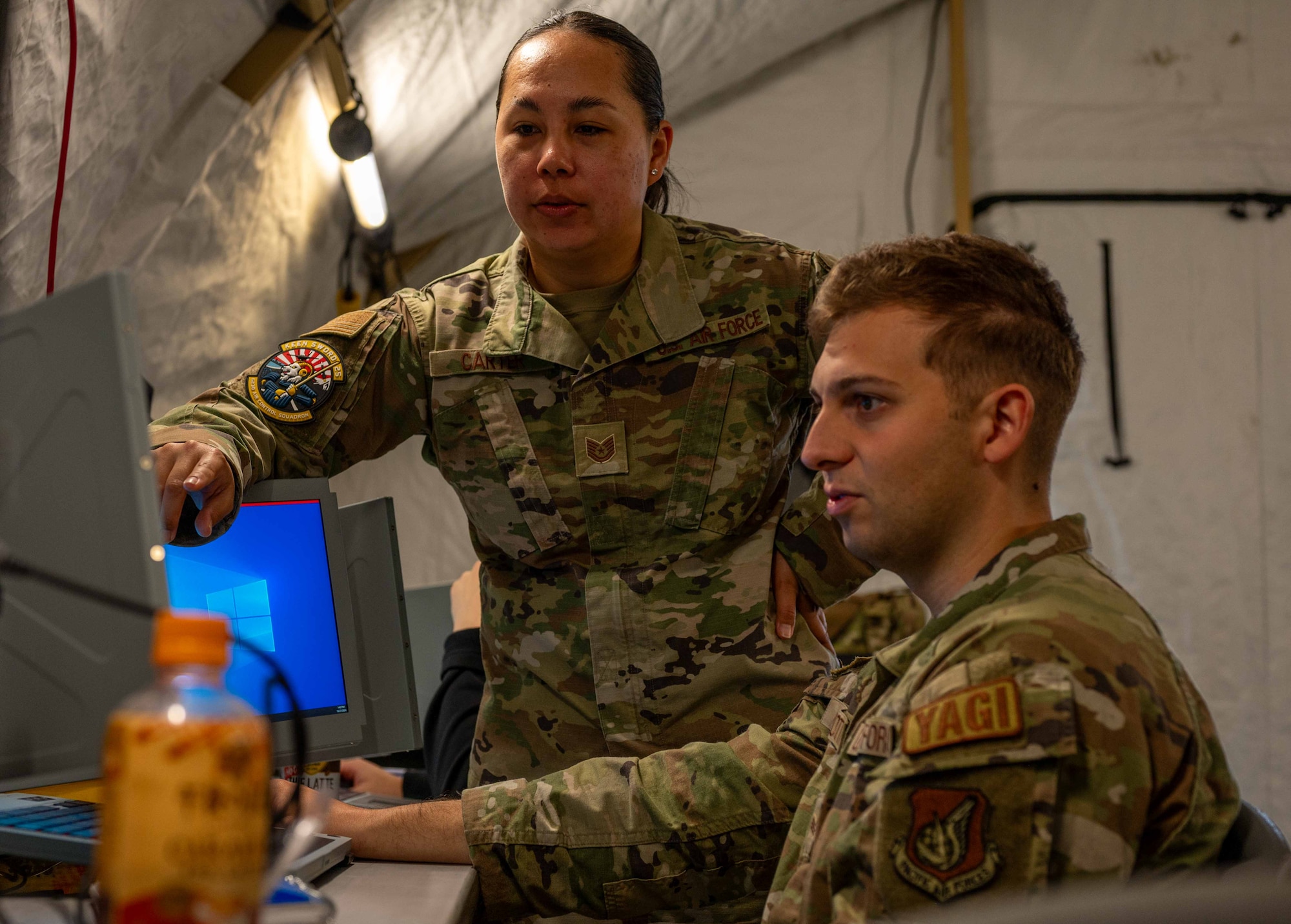 U.S. Air Force Tech. Sgt. Sherraye Carter, 623rd Air Control Squadron noncommissioned officer in charge of command and control integrations, and Senior Airman Jaedan Delzotti, 623rd ACS cyber systems officer, set up the Tactical Operations Center - Light systems during exercise Keen Sword 25 at Misawa Air Base, Japan, Oct. 28, 2024.