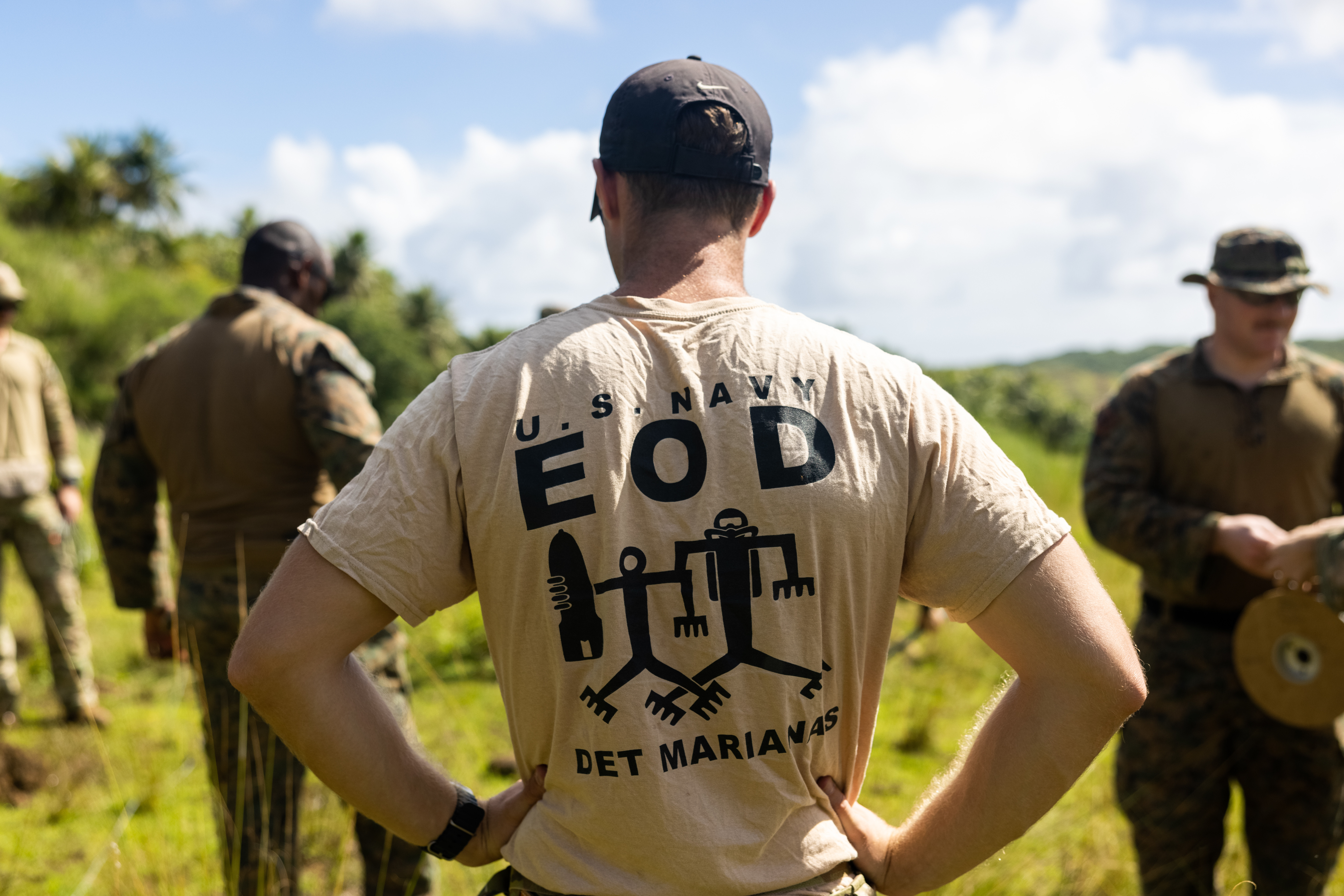 A U.S. Navy Sailor with explosive ordnance disposal, Detachment Marianas, supervises Marines from Marine Corps Base Camp Blaz and the 15th Marine Expeditionary Unit as they lay out detonation wire during a joint service EOD range on Naval Base Guam Ordnance Annex, Guam, Oct. 31, 2024. MCB Camp Blaz and 15th MEU Marines participated in a joint service EOD range in order to increase tactical proficiency, as well as strengthen the interservice connection between EOD teams. (Marine Corps photo by Cpl. Ryan Little)