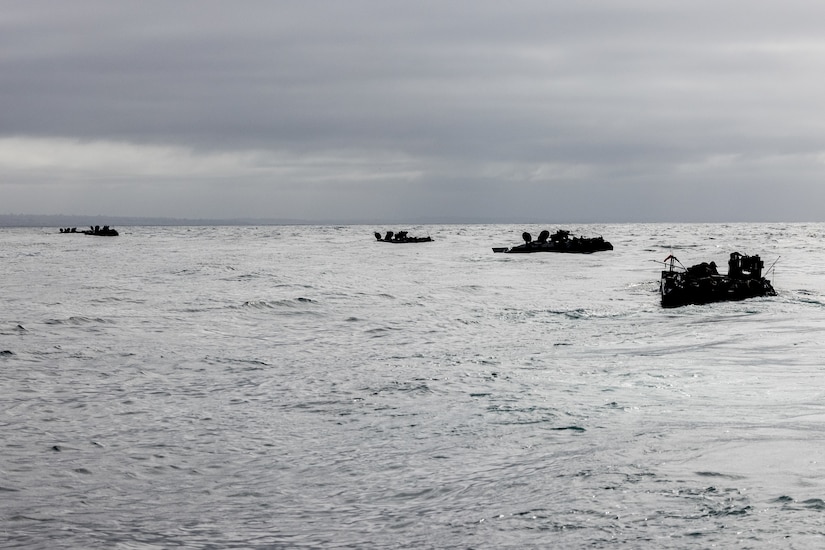 Marines ride in rubber boats.