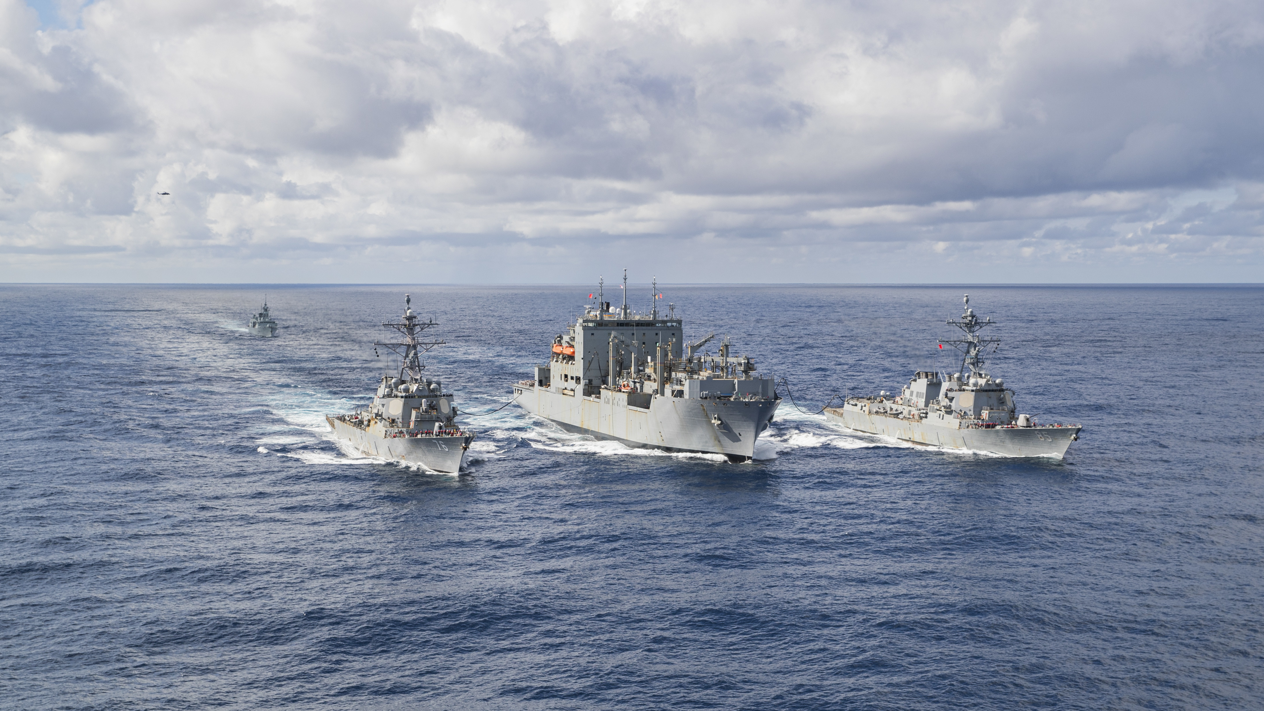 USNS Carl Brashear (T-AKE 7) replenishes USS McCampbell (DDG 85) and USS Higgins (DDG 76) as HMCS Ottawa (FFH 341) follows in the Philippine Sea.