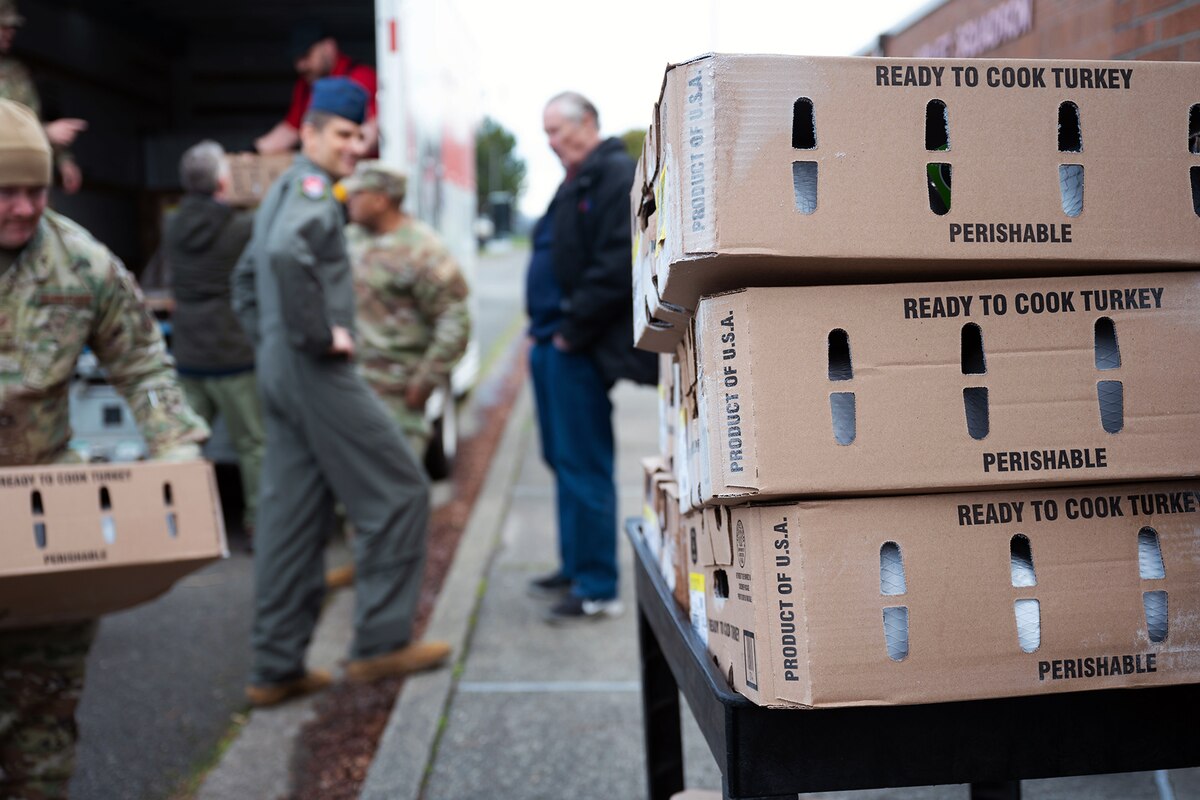 Service member unload boxes from a truck.