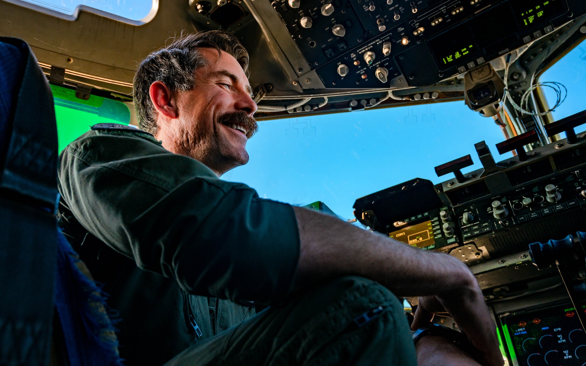 U.S. Air Force Maj. Andrew Mazzarelli, 313th Airlift Squadron chief of standardization and evaluation, engages with cadets and fellow officers following a safe landing.