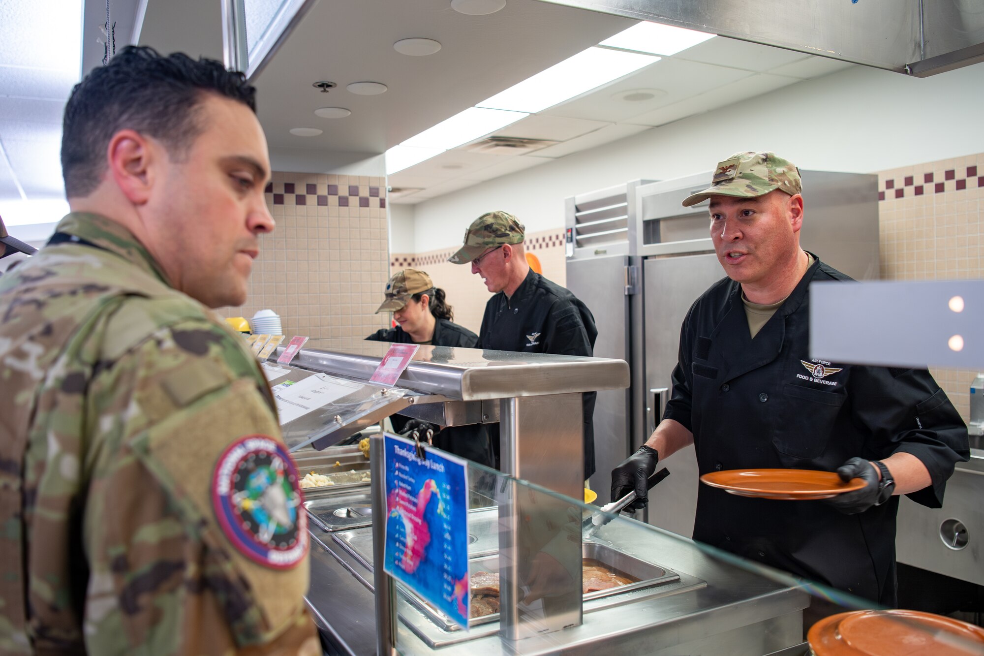 Unifirmed members serve foot at DFAC.