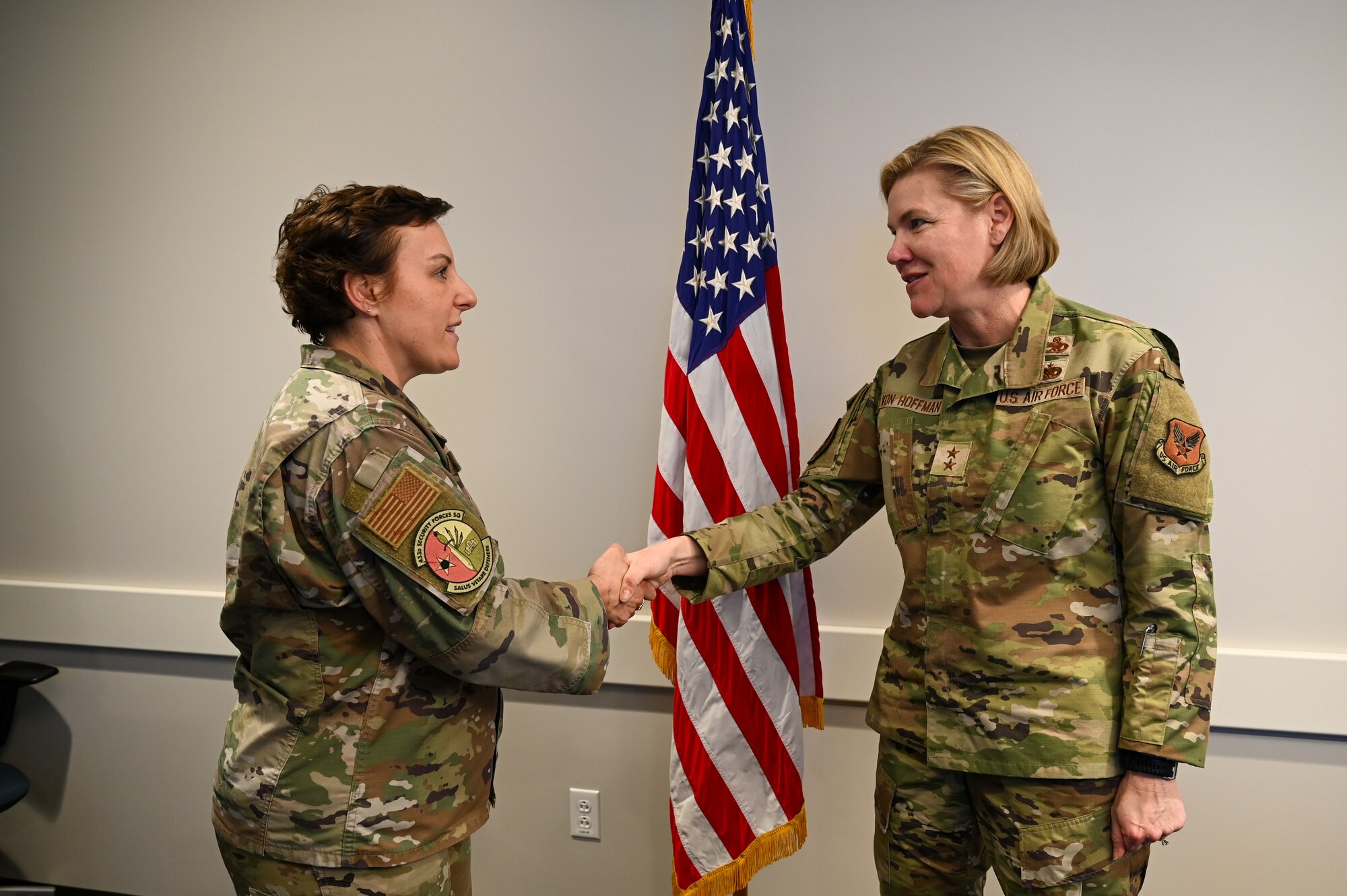 Senior Master Sgt. Catherine Falcon, 433rd Security Forces Squadron superintendent, accepts a commander’s coin from Maj. Gen. C. McCauley von Hoffman, Deputy to the Chief of Air Force Reserve, Headquarters U.S. Air Force, at Joint Base San Antonio-Lackland, Texas, Nov. 19, 2024.
