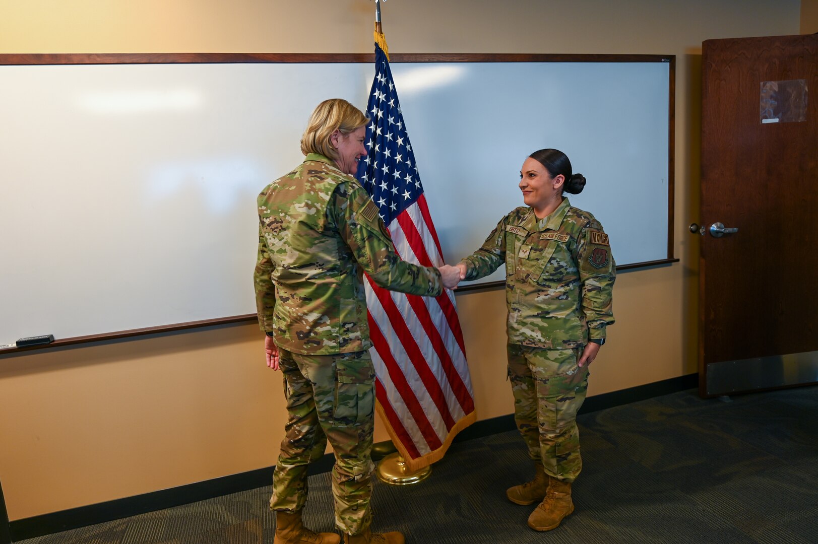 Senior Airman Erica Ortiz, a 433rd Maintenance Group production controller, accepts a commander’s coin from Maj. Gen. C. McCauley von Hoffman, Deputy to the Chief of Air Force Reserve, Headquarters U.S. Air Force, at Joint Base San Antonio-Lackland, Texas, Nov. 19, 2024.