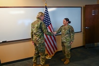 Senior Airman Erica Ortiz, a 433rd Maintenance Group production controller, accepts a commander’s coin from Maj. Gen. C. McCauley von Hoffman, Deputy to the Chief of Air Force Reserve, Headquarters U.S. Air Force, at Joint Base San Antonio-Lackland, Texas, Nov. 19, 2024.