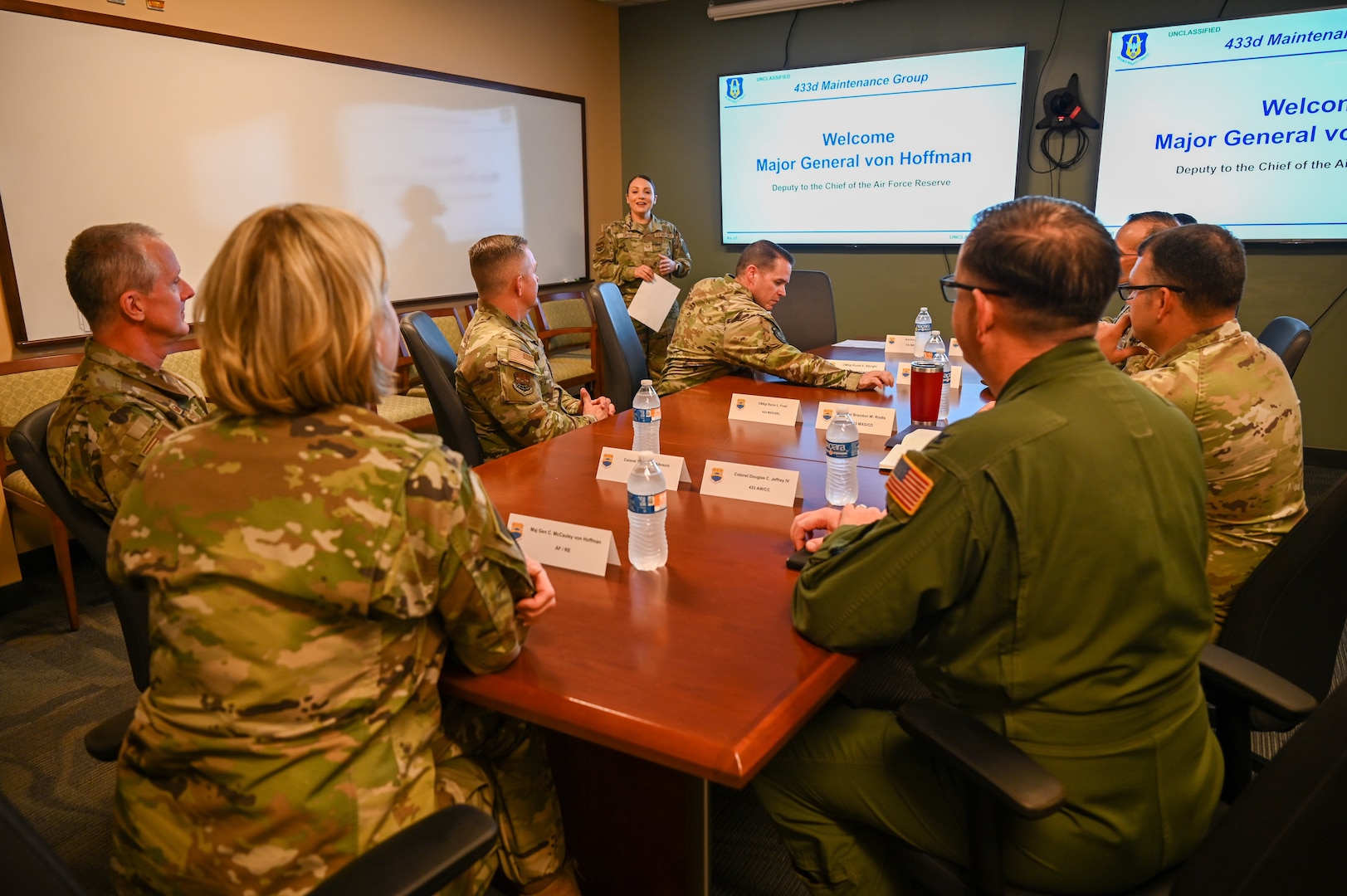 Senior Airman Erica Ortiz, a 433rd Maintenance Group production controller, briefs Maj. Gen. C. McCauley von Hoffman, Deputy to the Chief of Air Force Reserve, Headquarters U.S. Air Force, at Joint Base San Antonio-Lackland, Texas, Nov. 19, 2024.