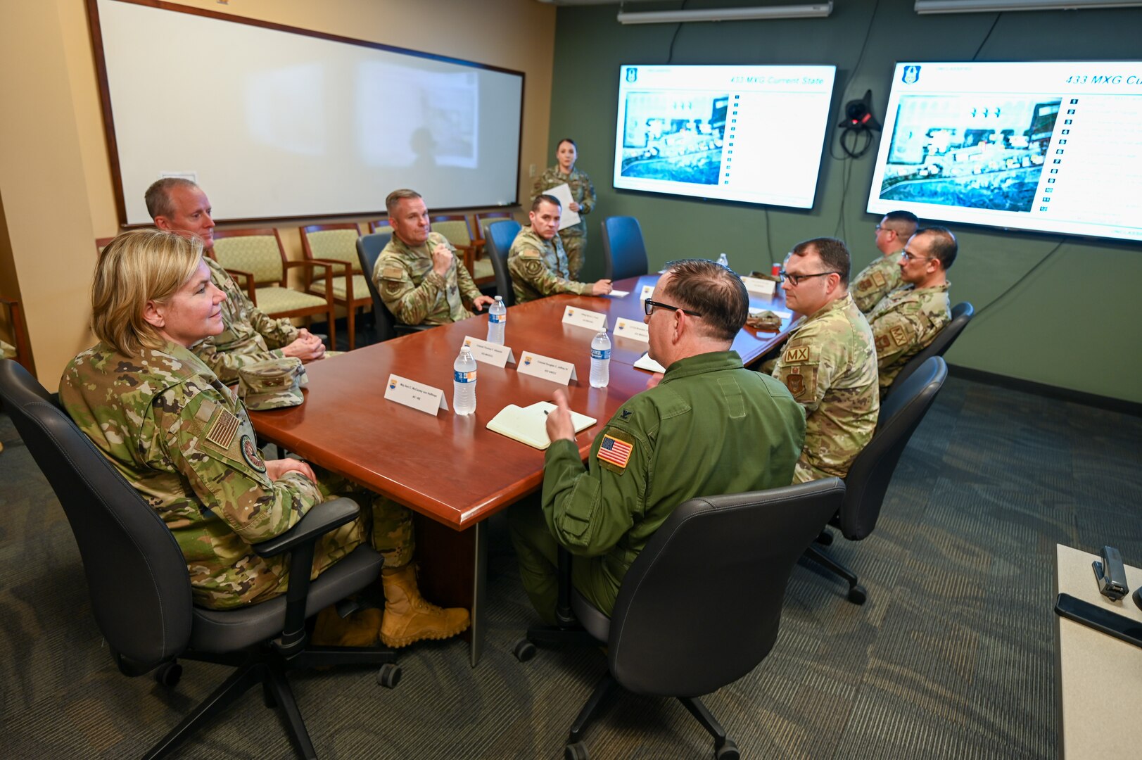 Senior Airman Erica Ortiz, a 433rd Maintenance Group production controller, briefs Maj. Gen. C. McCauley von Hoffman, Deputy to the Chief of Air Force Reserve, Headquarters U.S. Air Force, at Joint Base San Antonio-Lackland, Texas, Nov. 19, 2024.