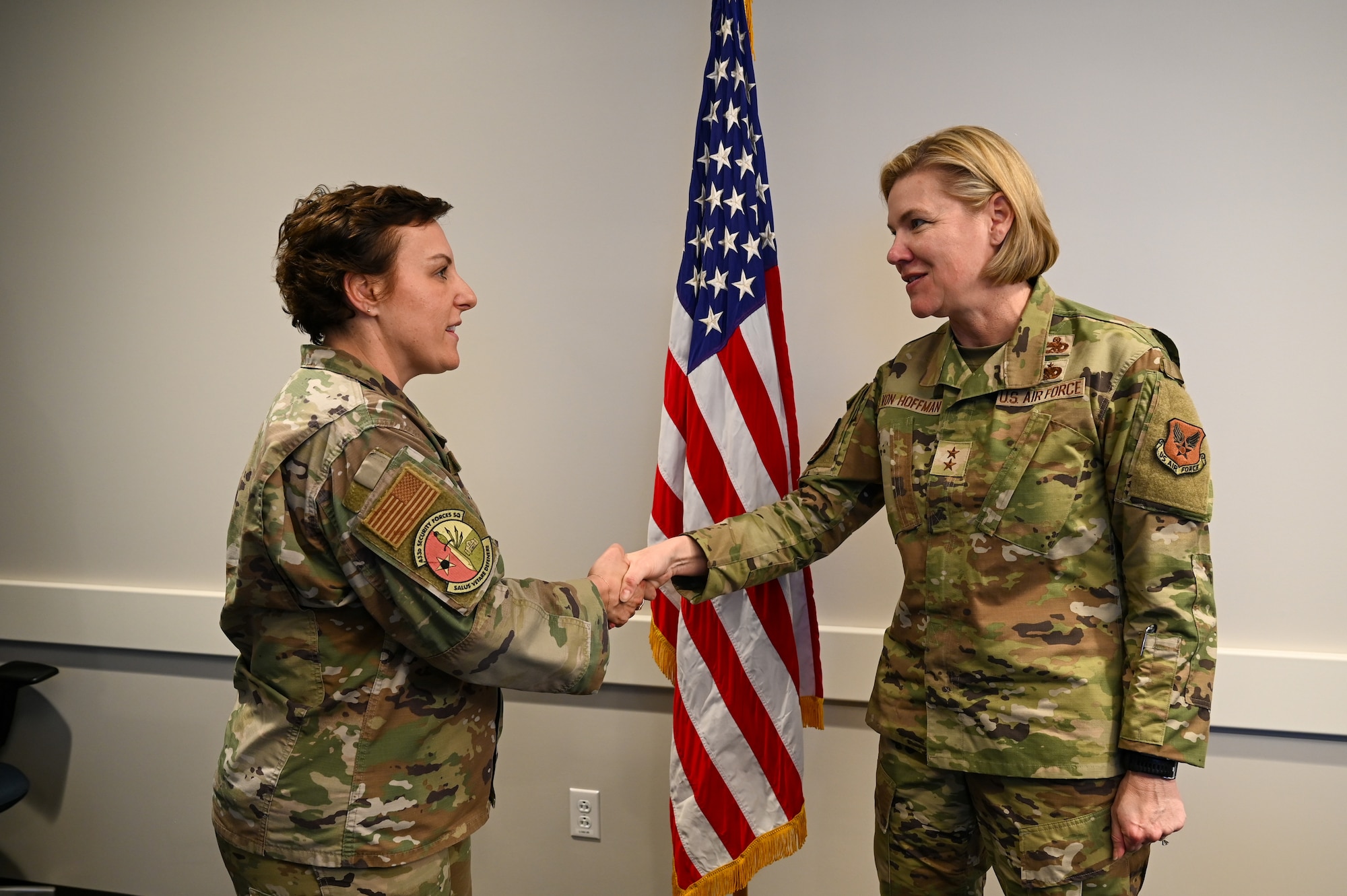 Senior Master Sgt. Catherine Falcon, 433rd Security Forces Squadron superintendent, accepts a commander’s coin from Maj. Gen. C. McCauley von Hoffman, Deputy to the Chief of Air Force Reserve, Headquarters U.S. Air Force, at Joint Base San Antonio-Lackland, Texas, Nov. 19, 2024.