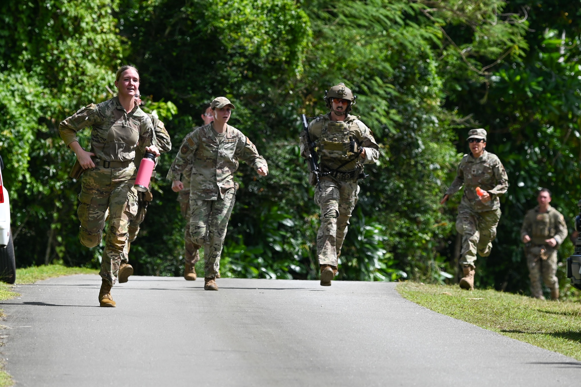 Airmen representing the 36th Security Forces Squadron in the 2024 Battle of the Branches run toward the finish line on Andersen Air Force Base, Guam, Nov. 22, 2024. 36 SFS was one of seven competing teams finishing with the fastest overall time. (U.S. Air Force photo by Airman 1st Class Natasha Ninete)