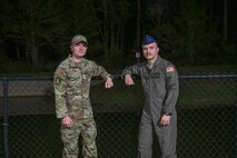 U.S. Air Force Senior Airman Kyle Hiday, assigned to the 1st Special Operations Wing and U.S. Air Force 1st Lt. Christian Munoz, assigned to the 492nd Special Operations Wing, pose in front of the retention pond where they saved a mother and her child in Navarre, Florida, November 25, 2024.