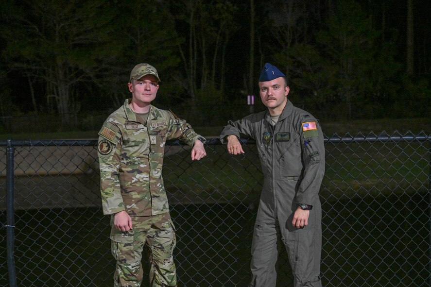 U.S. Air Force Senior Airman Kyle Hiday, assigned to the 1st Special Operations Wing and U.S. Air Force 1st Lt. Christian Munoz, assigned to the 492nd Special Operations Wing, pose in front of the retention pond where they saved a mother and her child in Navarre, Florida, November 25, 2024.