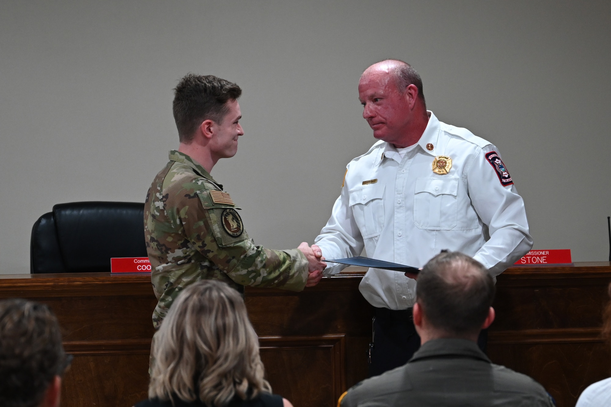Kevin Lewis, fire chief at Holley-Navarre Fire District, recognizes U.S. Air Force Senior Airman Kyle Hiday, assigned to the 1st Special Operations Wing, for his efforts in an off-base rescue at Holley-Navarre Fire Station 45 in Navarre Florida, Nov. 25, 2024.