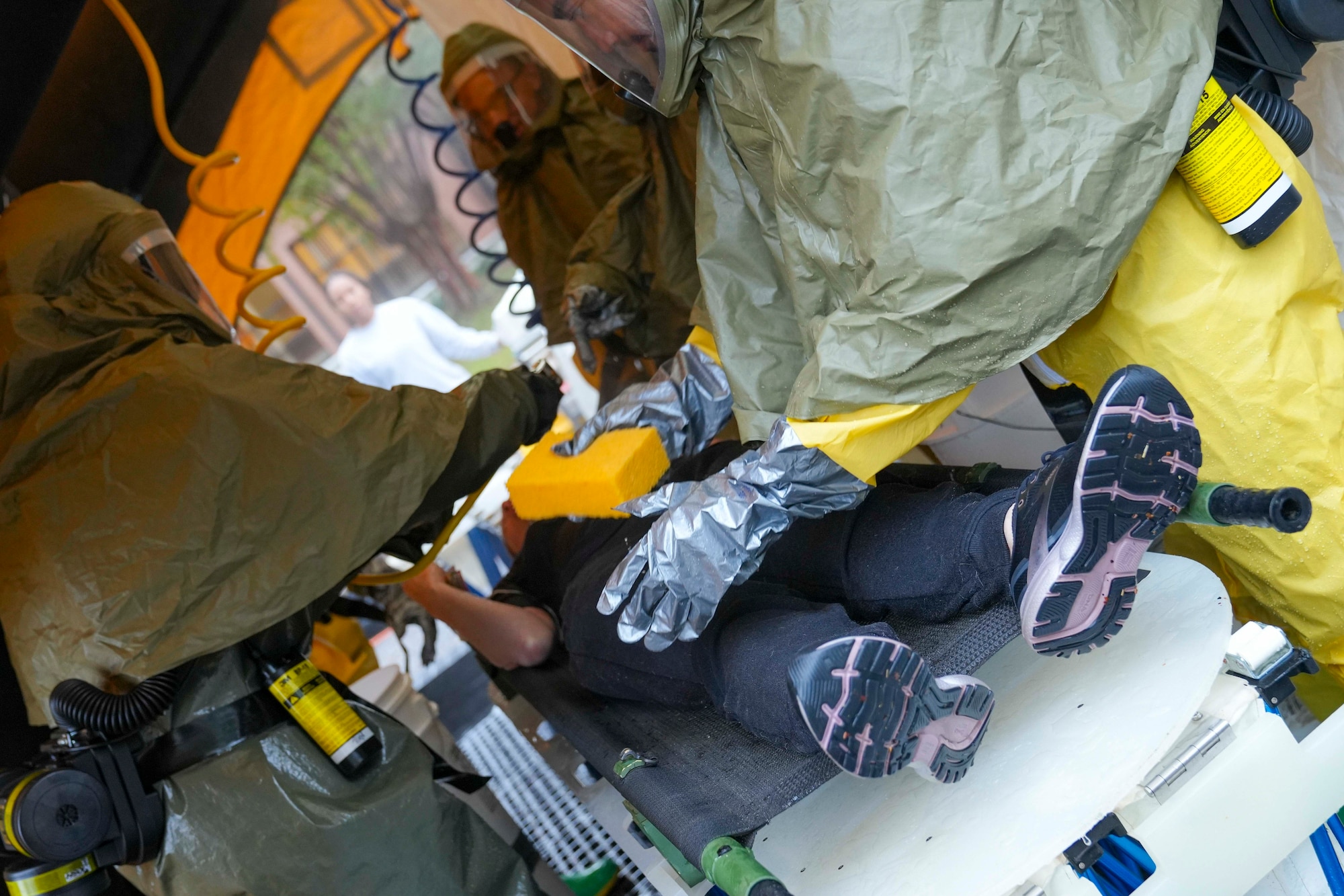 A patient receives a wash down in the decontamination tent after initial medical assessment during a mass casualty decontamination drill conducted at Robins Air Force Base, Georgia, Nov. 20, 2024.