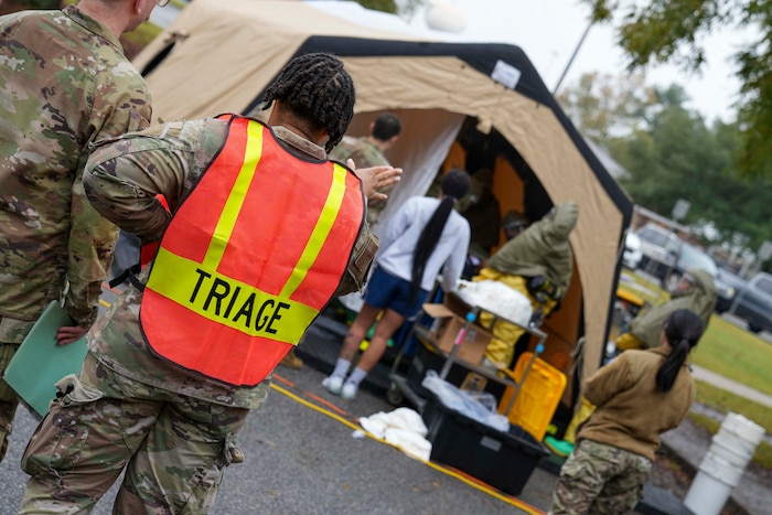 Members from the 78th Medical Group Manpower team await outside the decontamination wash down tent to transport patients to the triage area for medical treatment during a mass casualty decontamination drill conducted at Robins Air Force Base, Georgia, Nov. 20, 2024